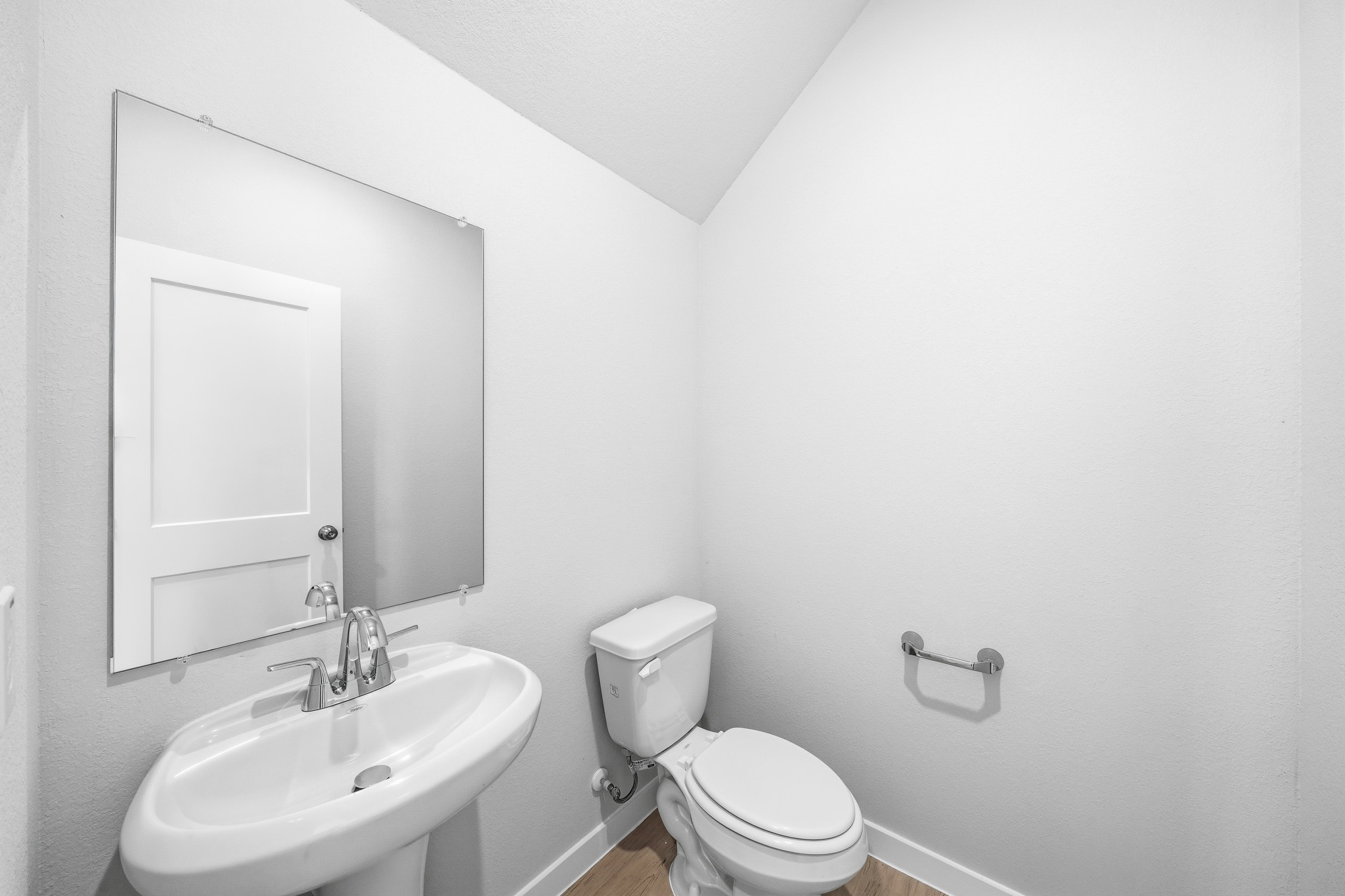 A bathroom with a toilet and sink.