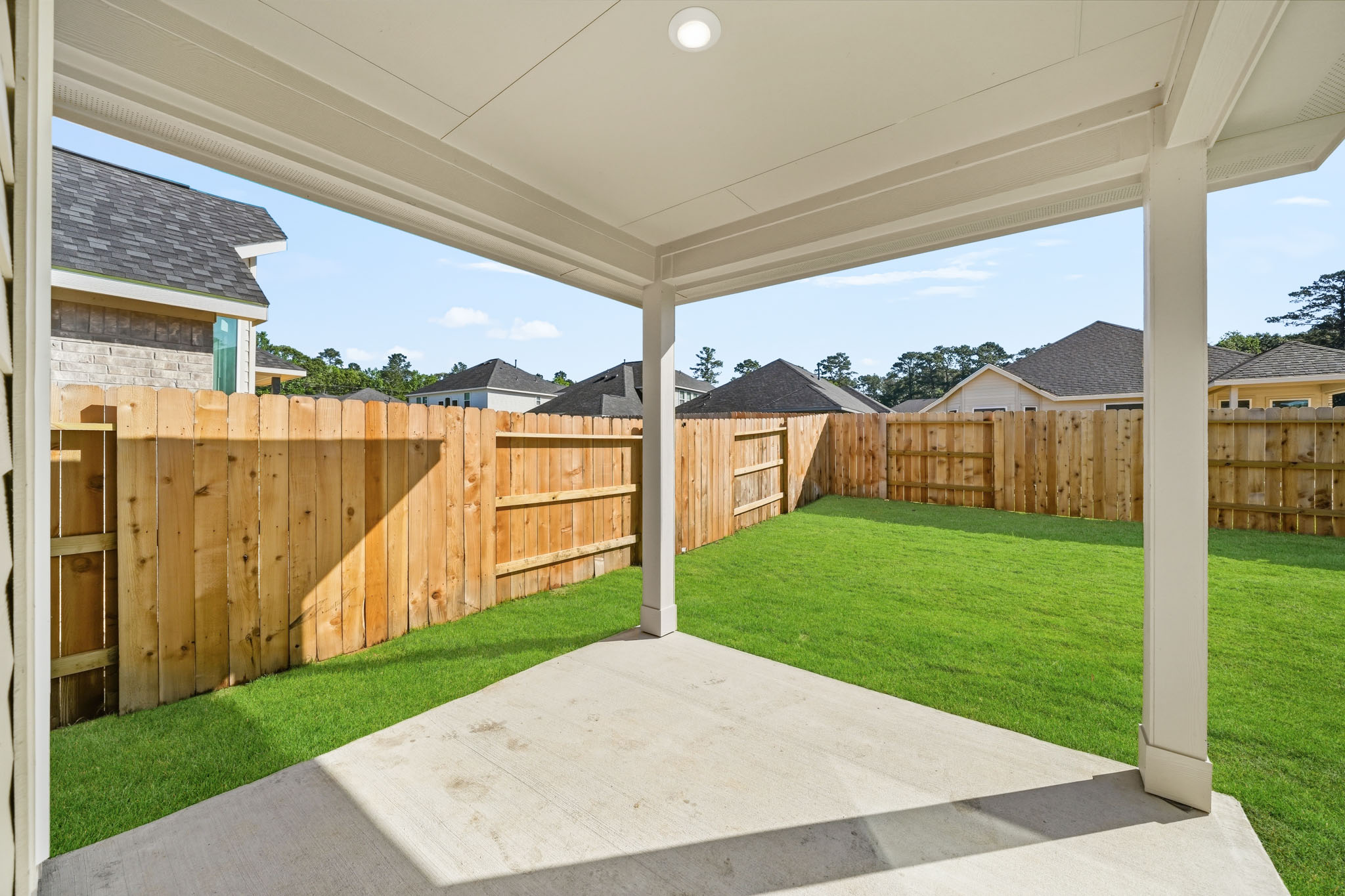 A backyard with a fence.