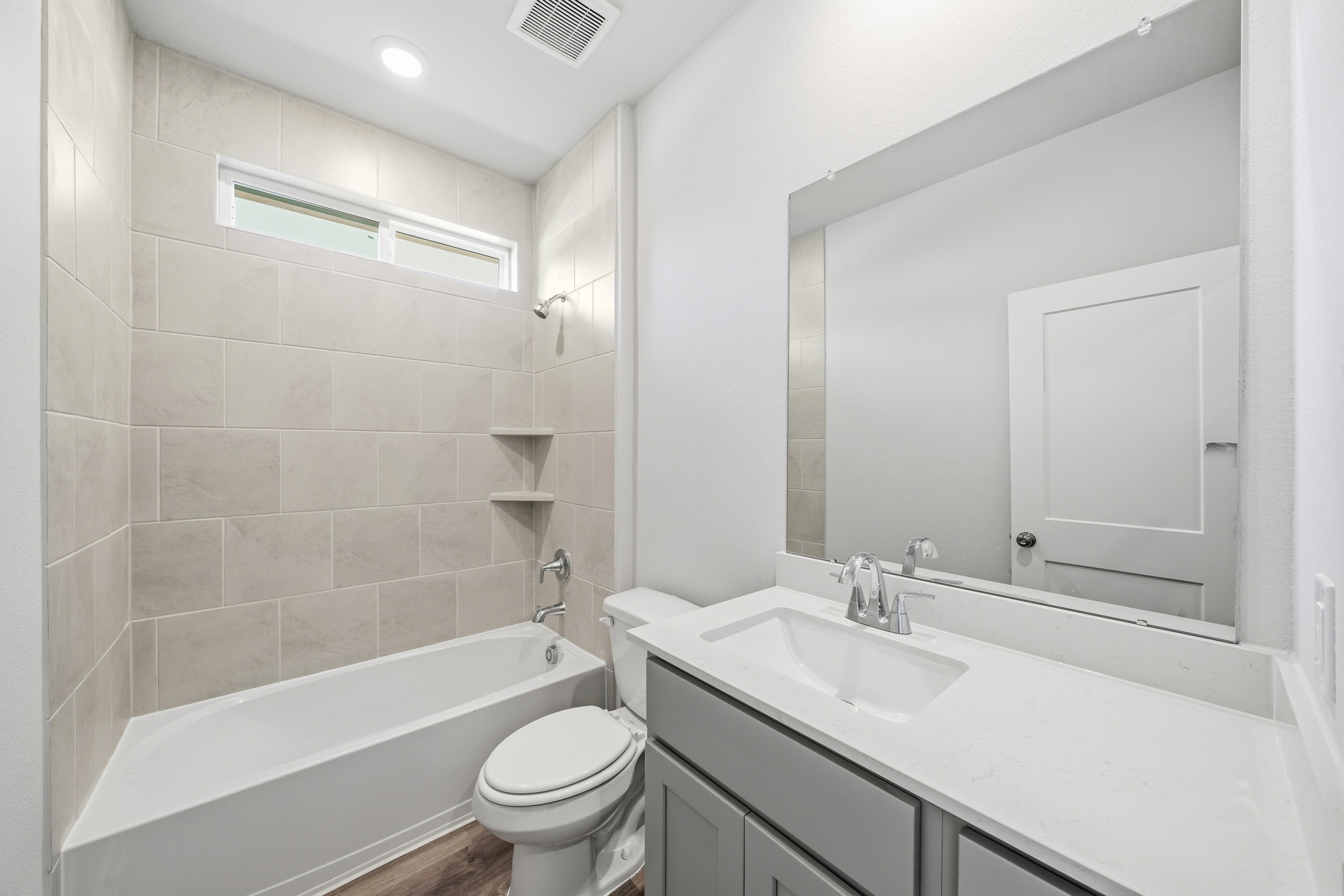A bathroom with a tub sink and toilet.