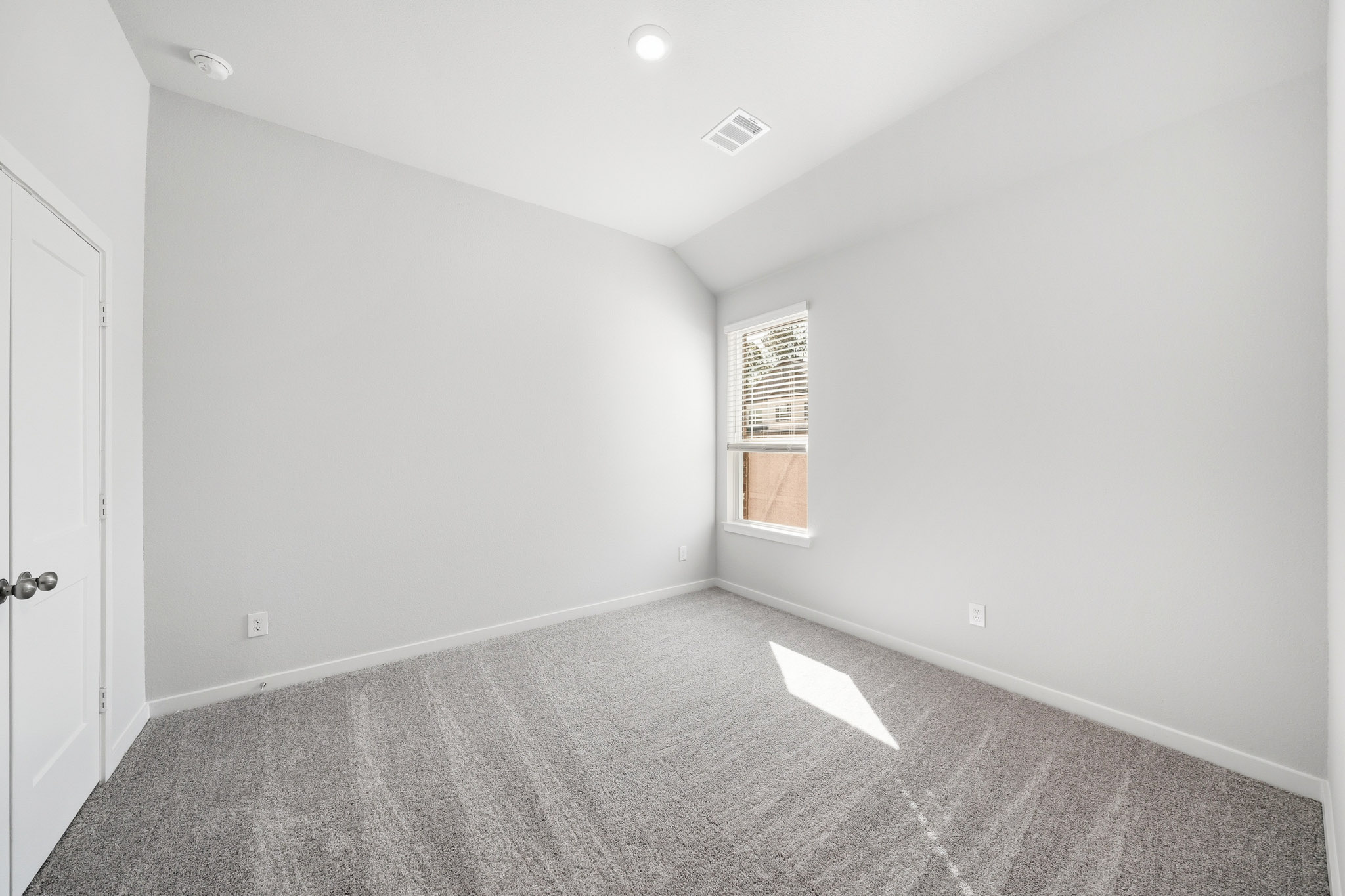 A room with a door and a window.