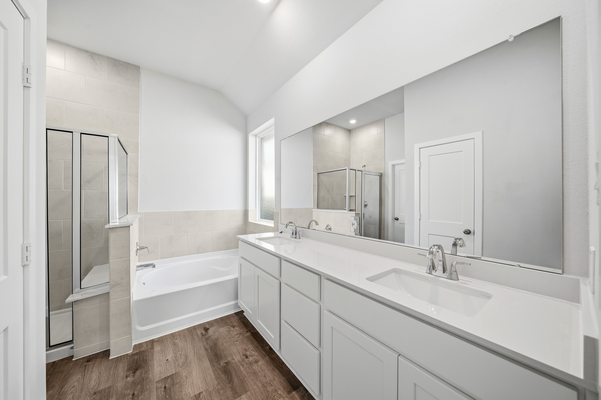 A bathroom with a large mirror.