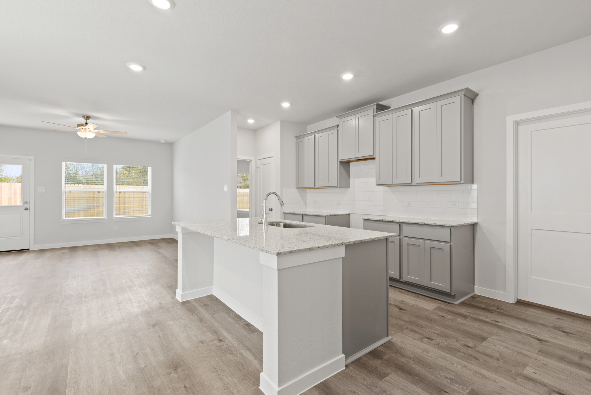 A kitchen with white cabinets.