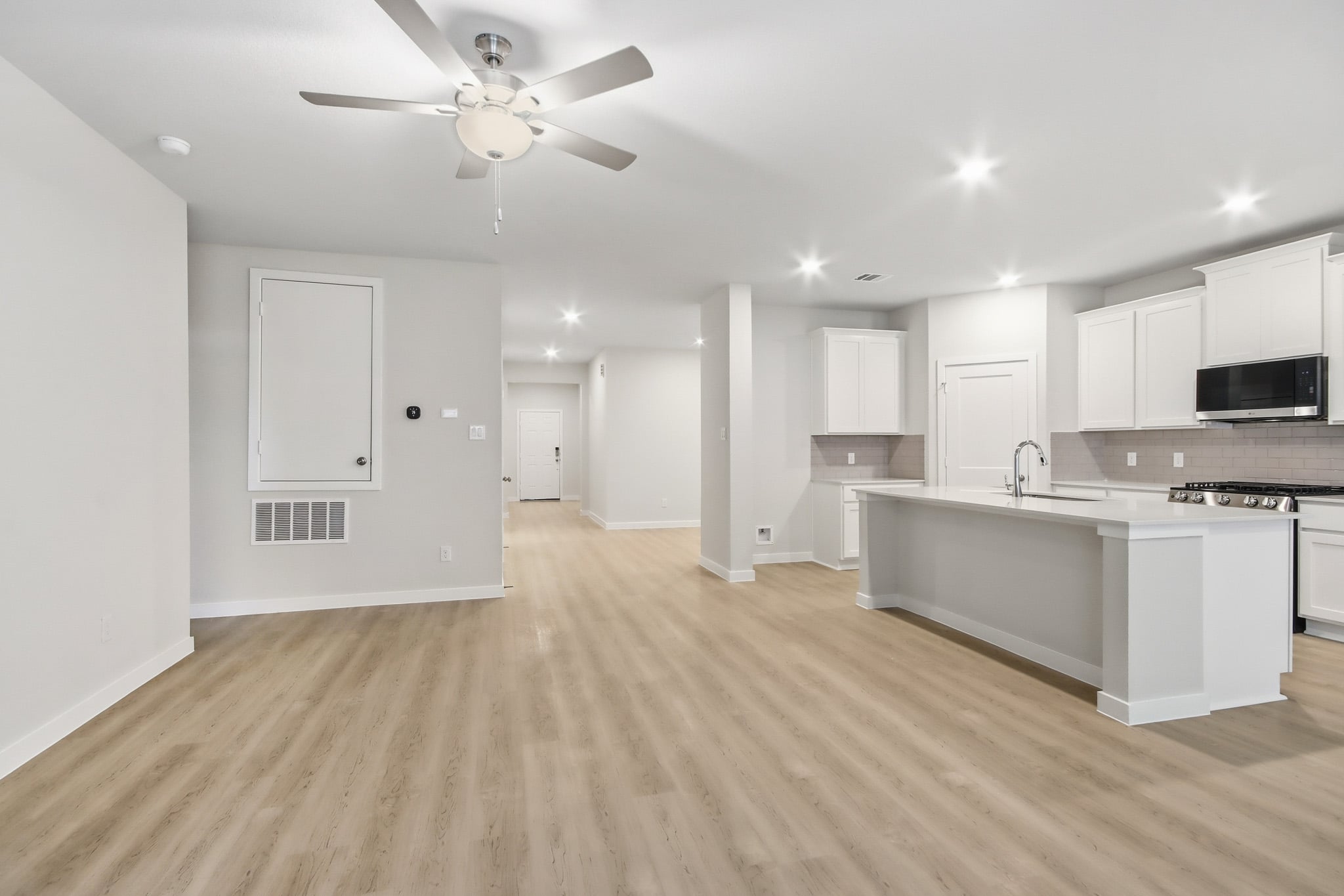 A kitchen with white cabinets.