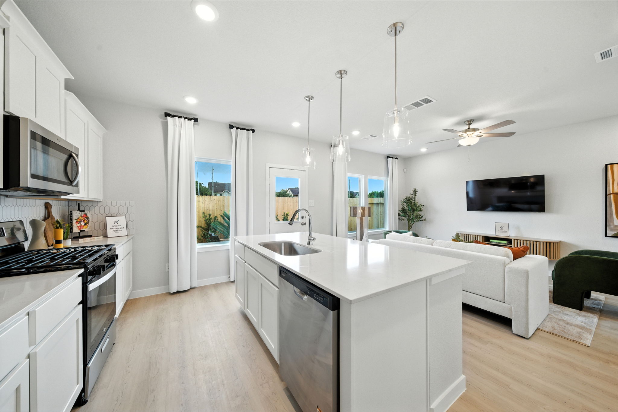 A kitchen with white cabinets.