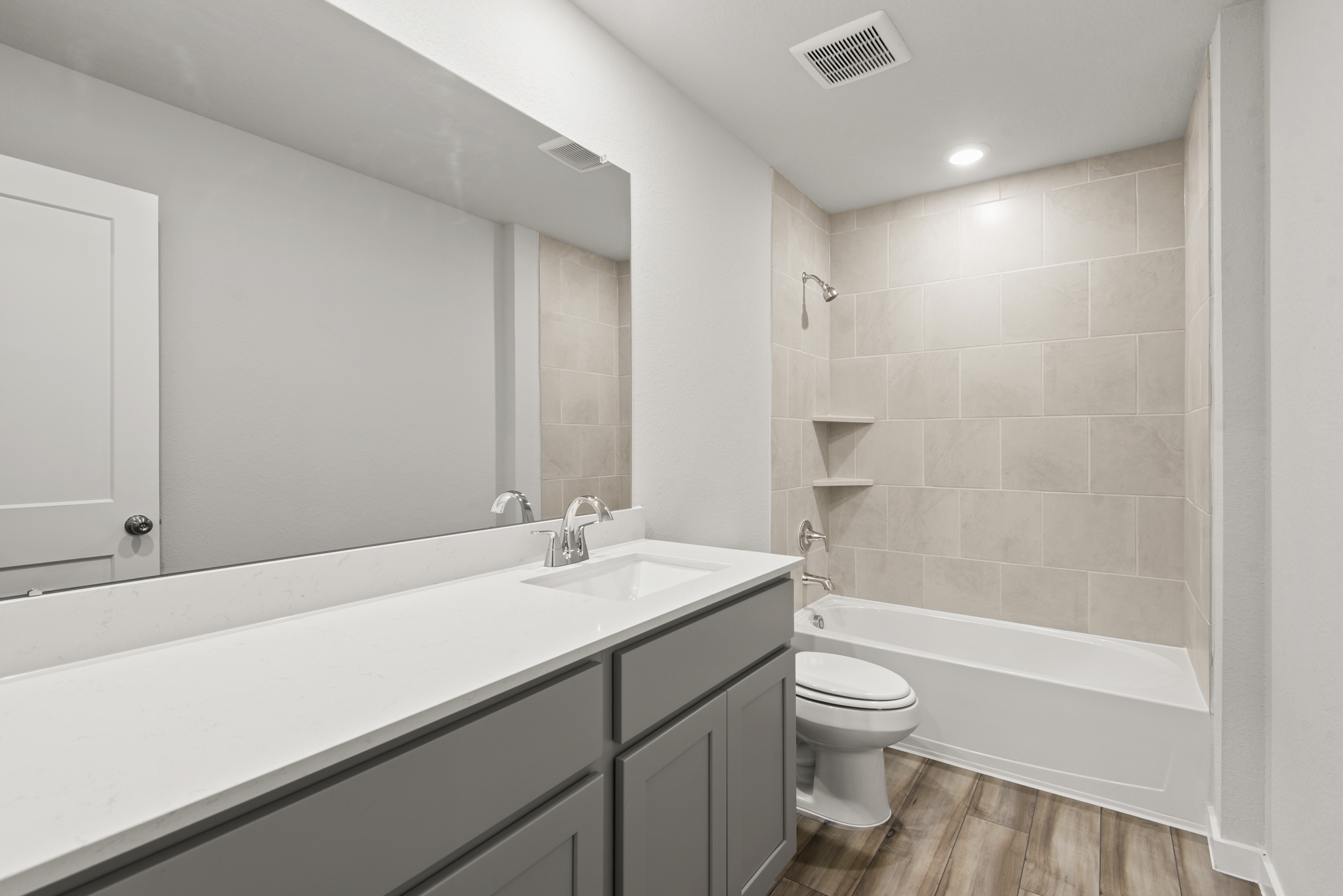 A bathroom with a tub sink and toilet.