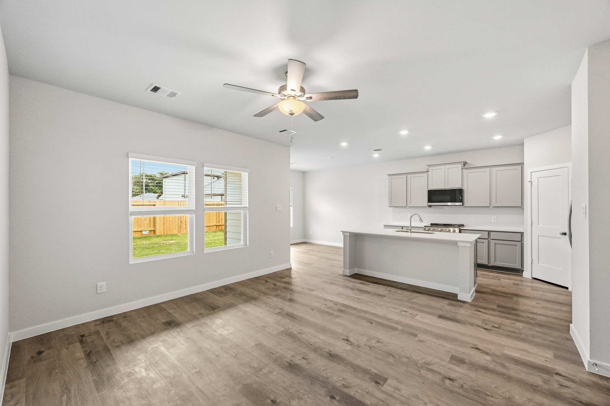 A kitchen with a wood floor.