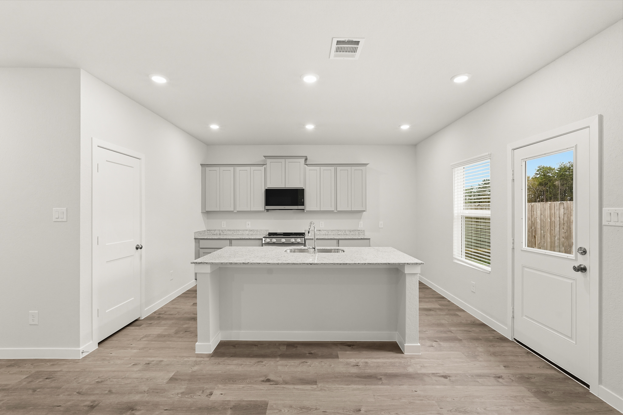 A kitchen with white cabinets.