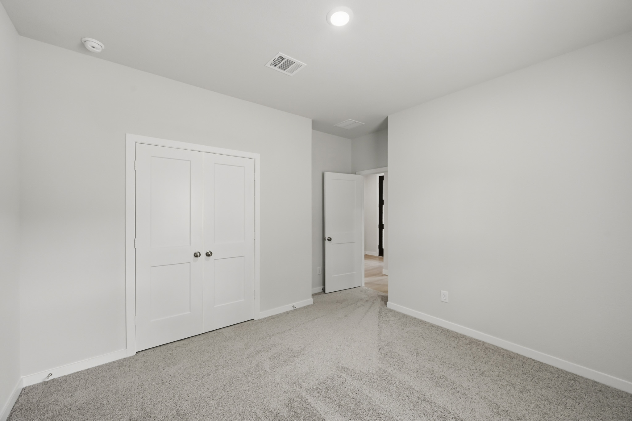 A hallway with white doors.
