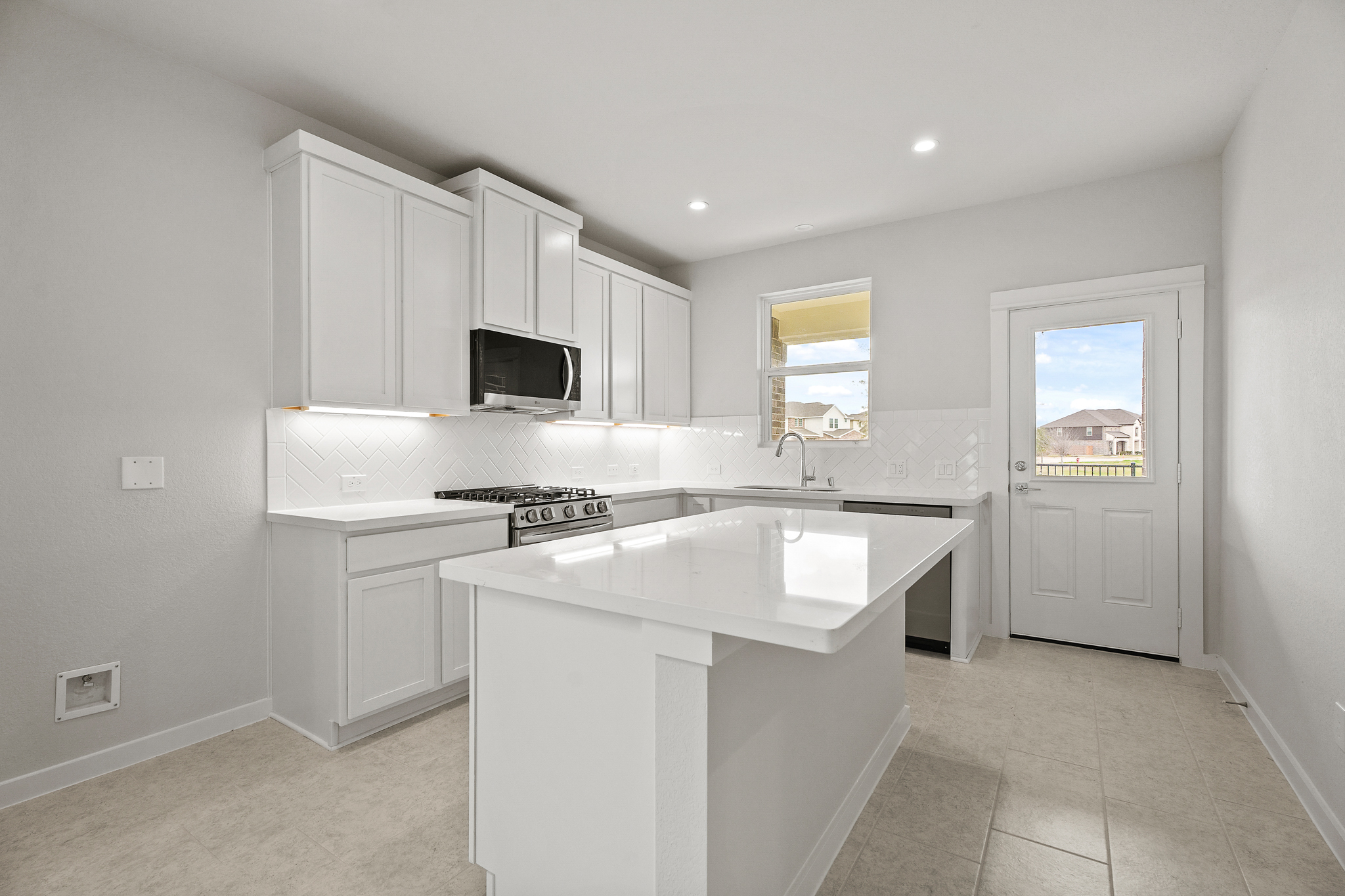 A kitchen with white cabinets.
