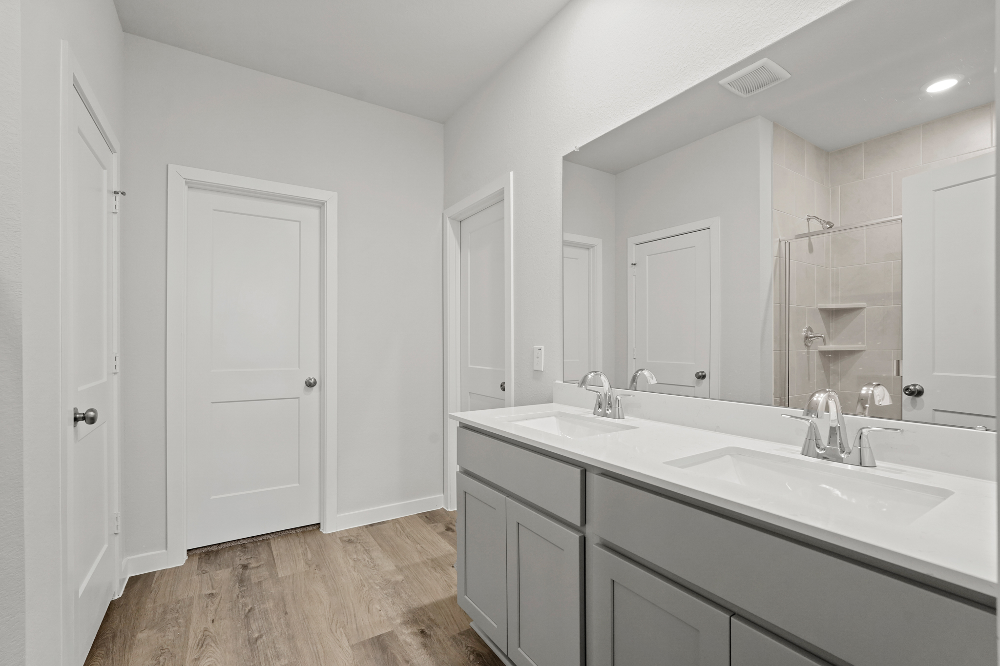 A bathroom with a large mirror.