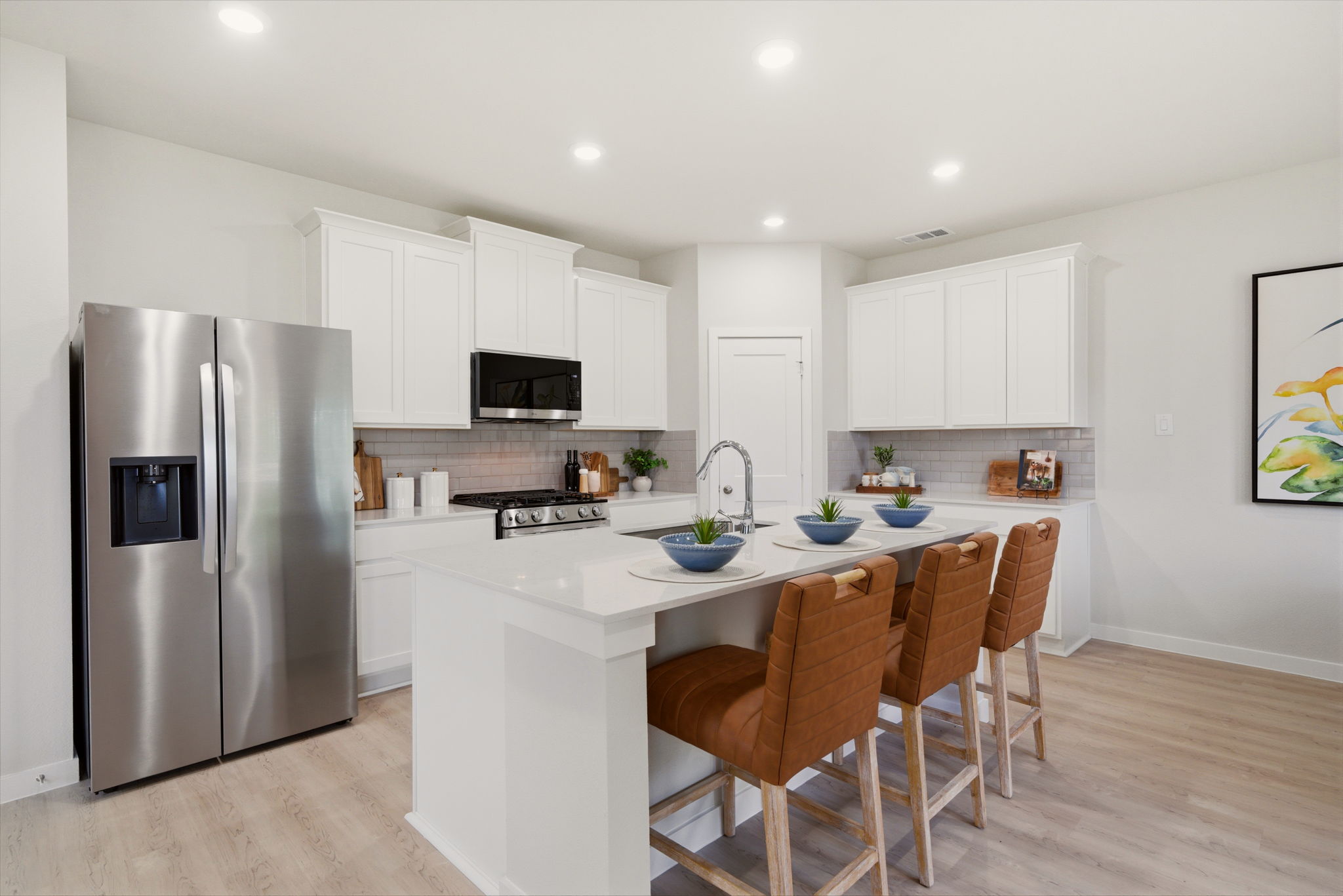 A kitchen with white cabinets.