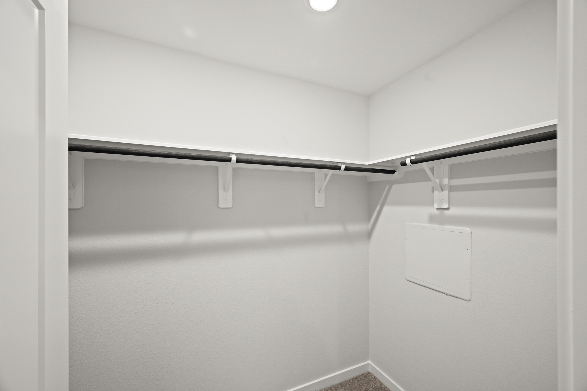 A white wall with a light on it.