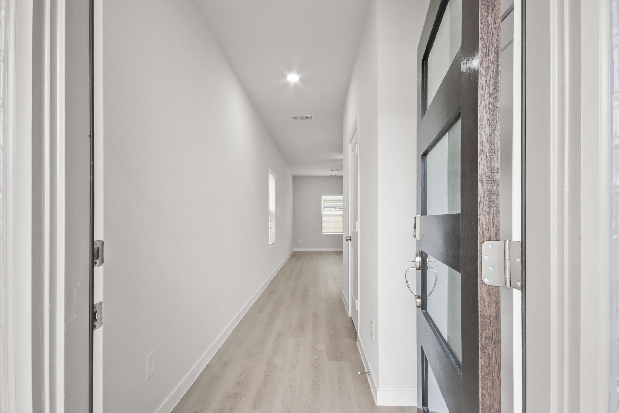 A hallway with white walls.