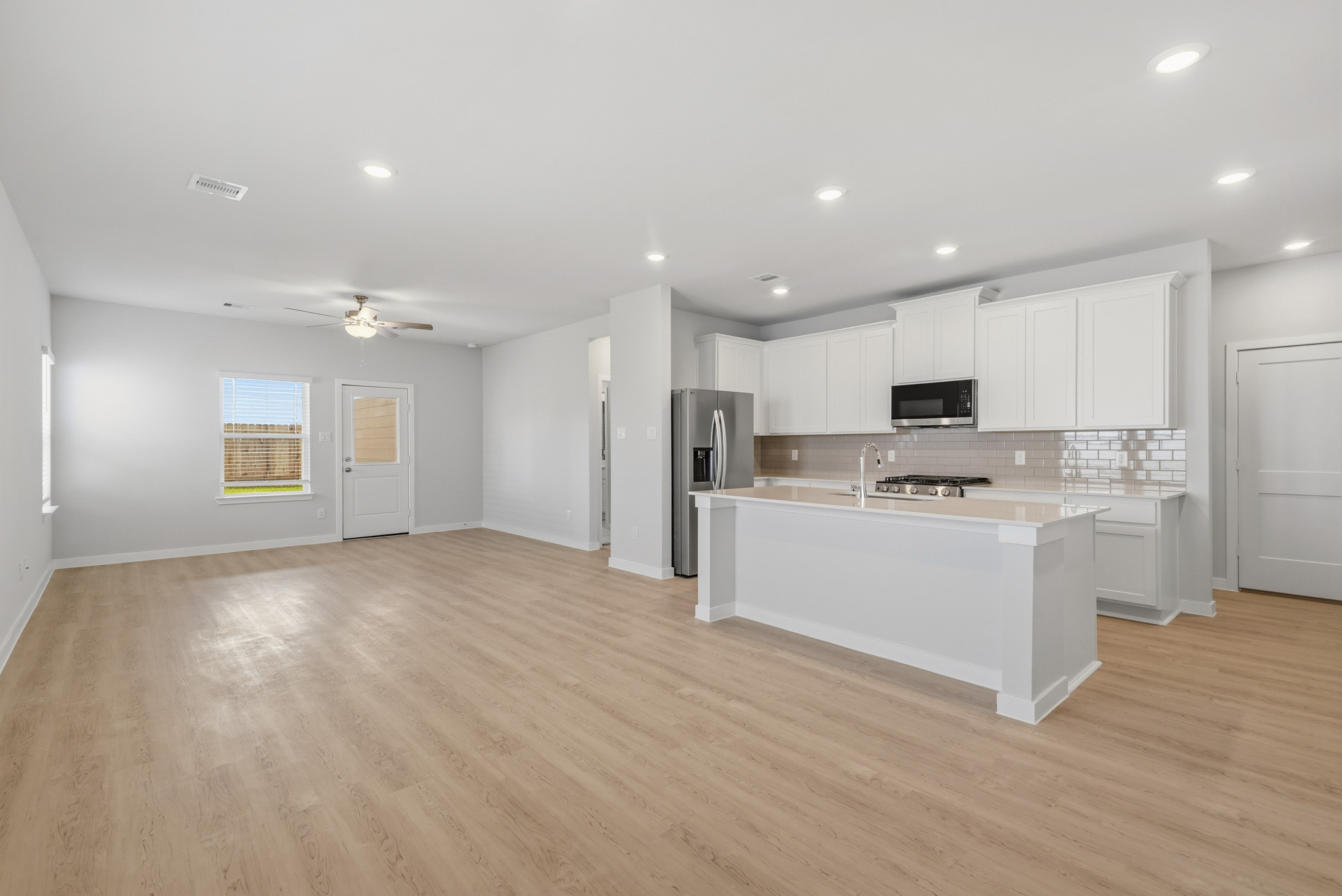 A kitchen with white cabinets.