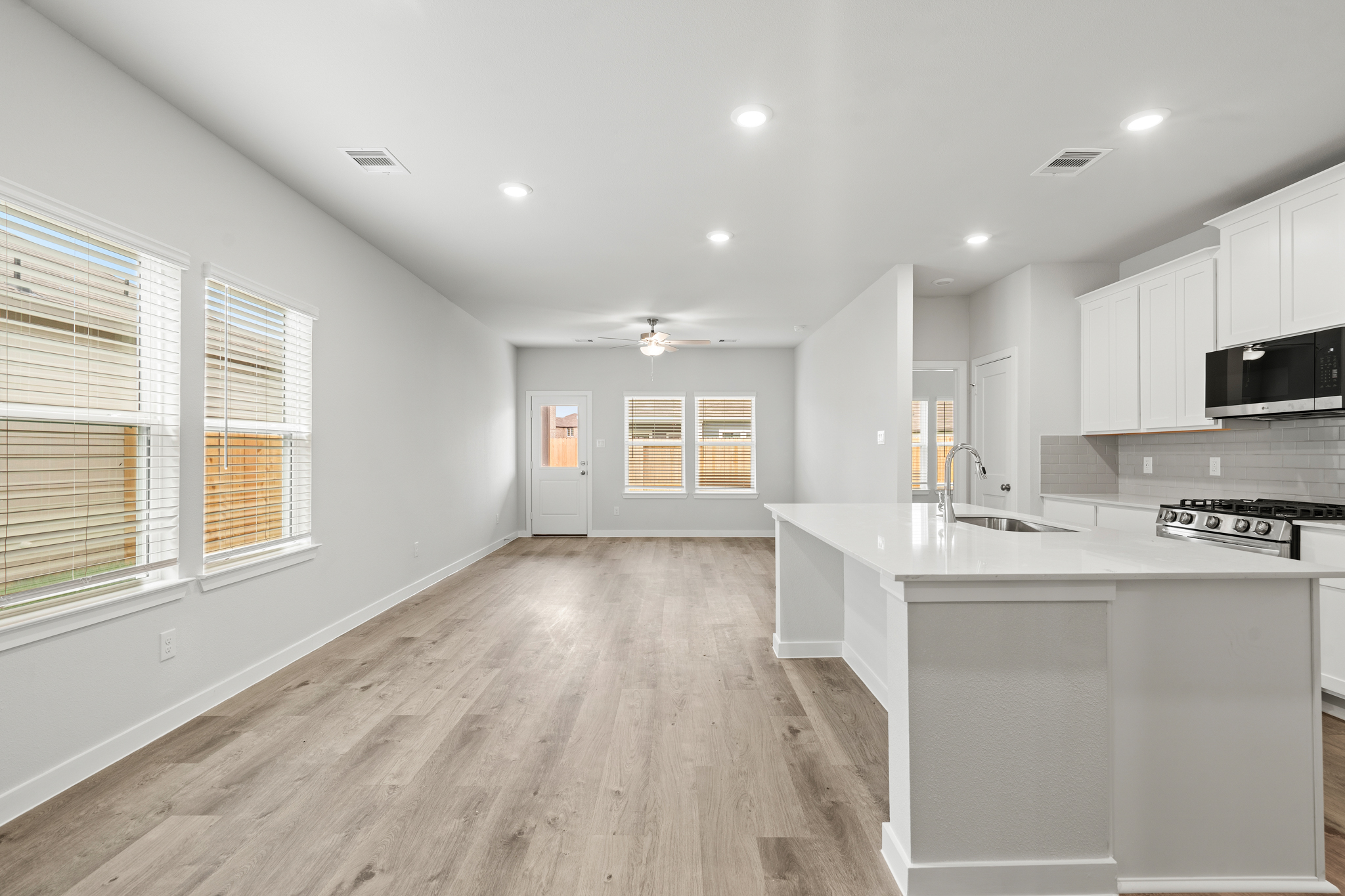 A kitchen with white cabinets.