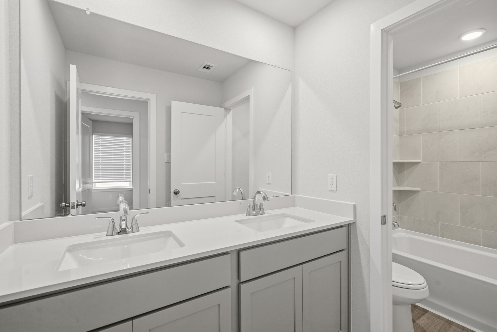A bathroom with a tub sink and toilet.