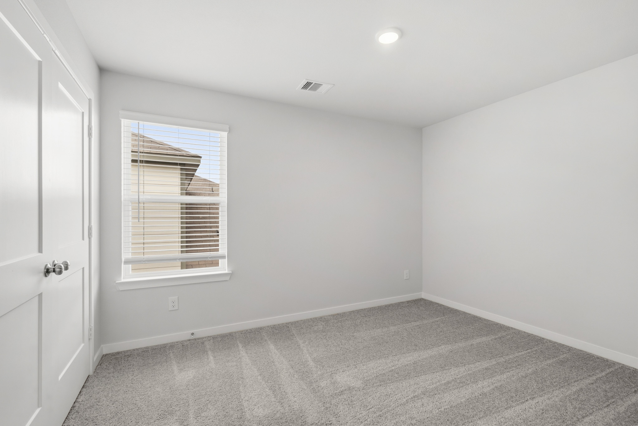 A room with a window and a door.