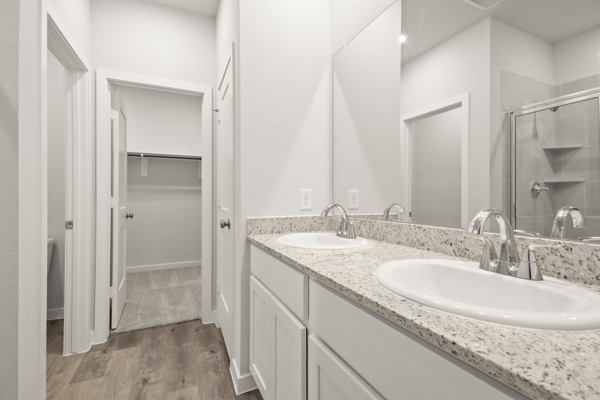 A bathroom with a large mirror.