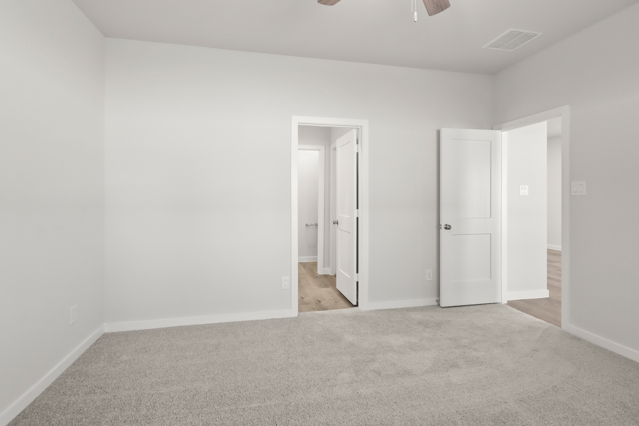 A hallway with white doors.