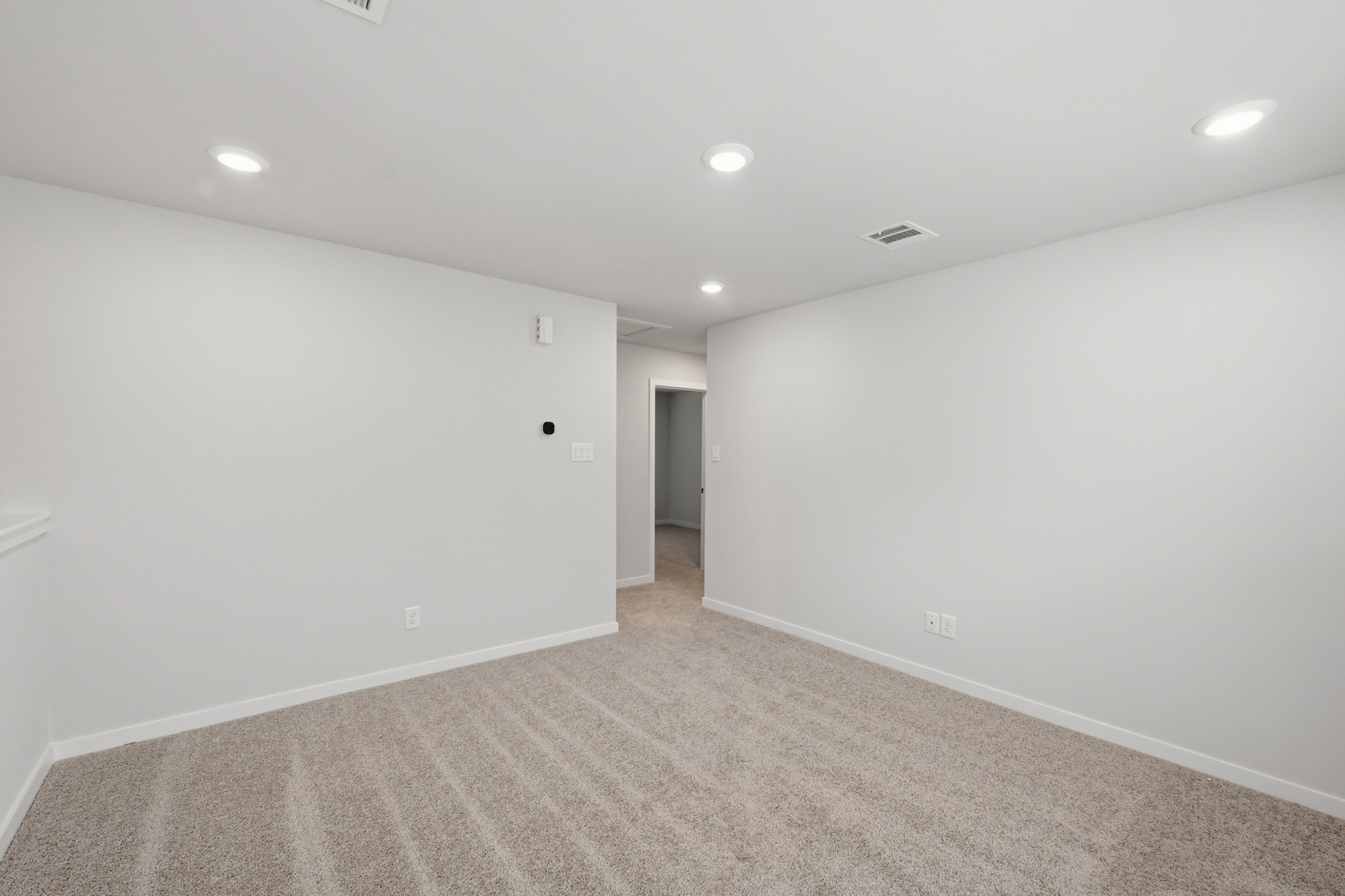 A hallway with white walls.