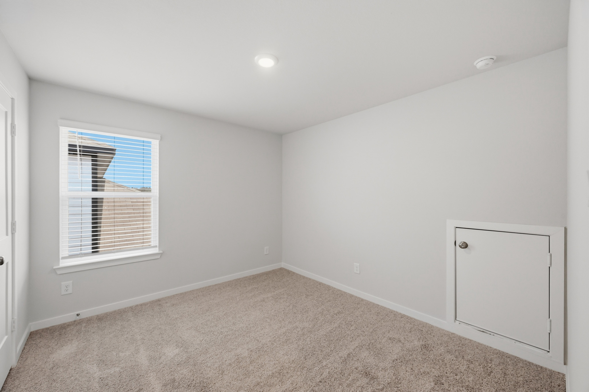 A room with a window and a door.