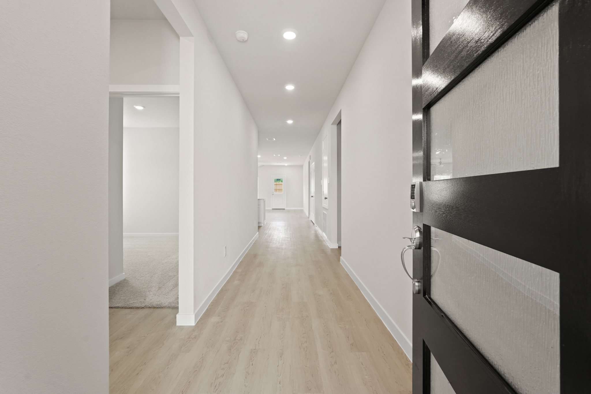 A hallway with white walls.
