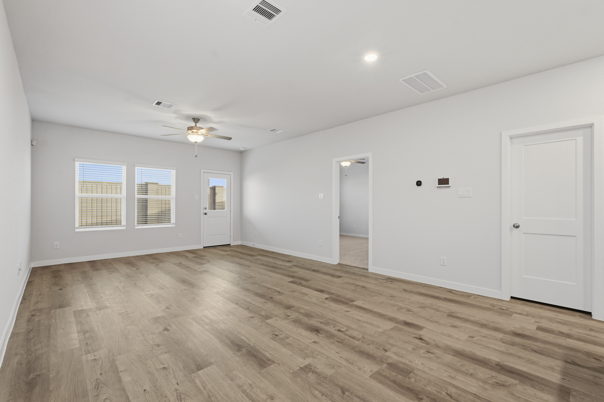A room with a wood floor and white walls.