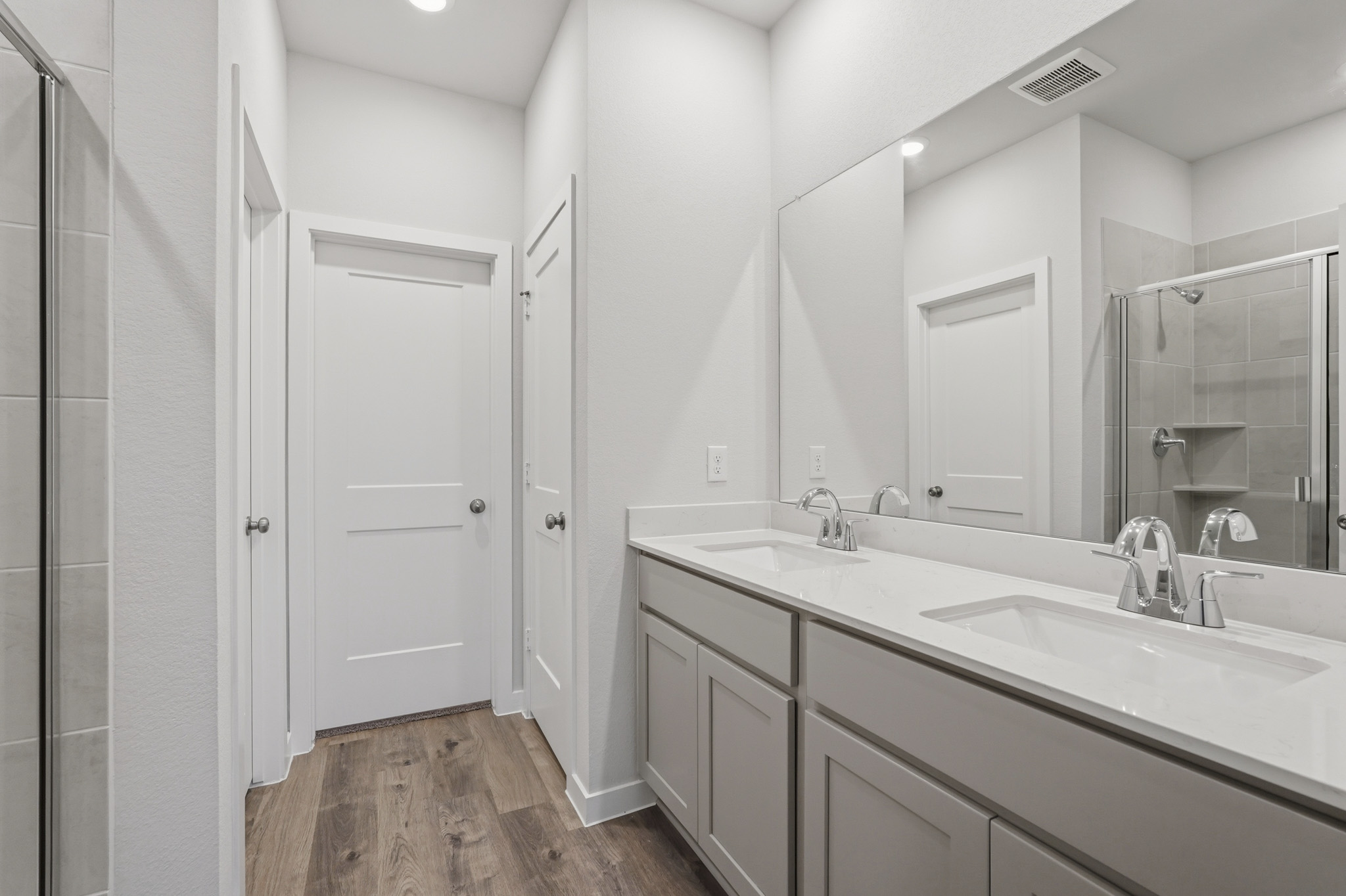 A bathroom with a large mirror.