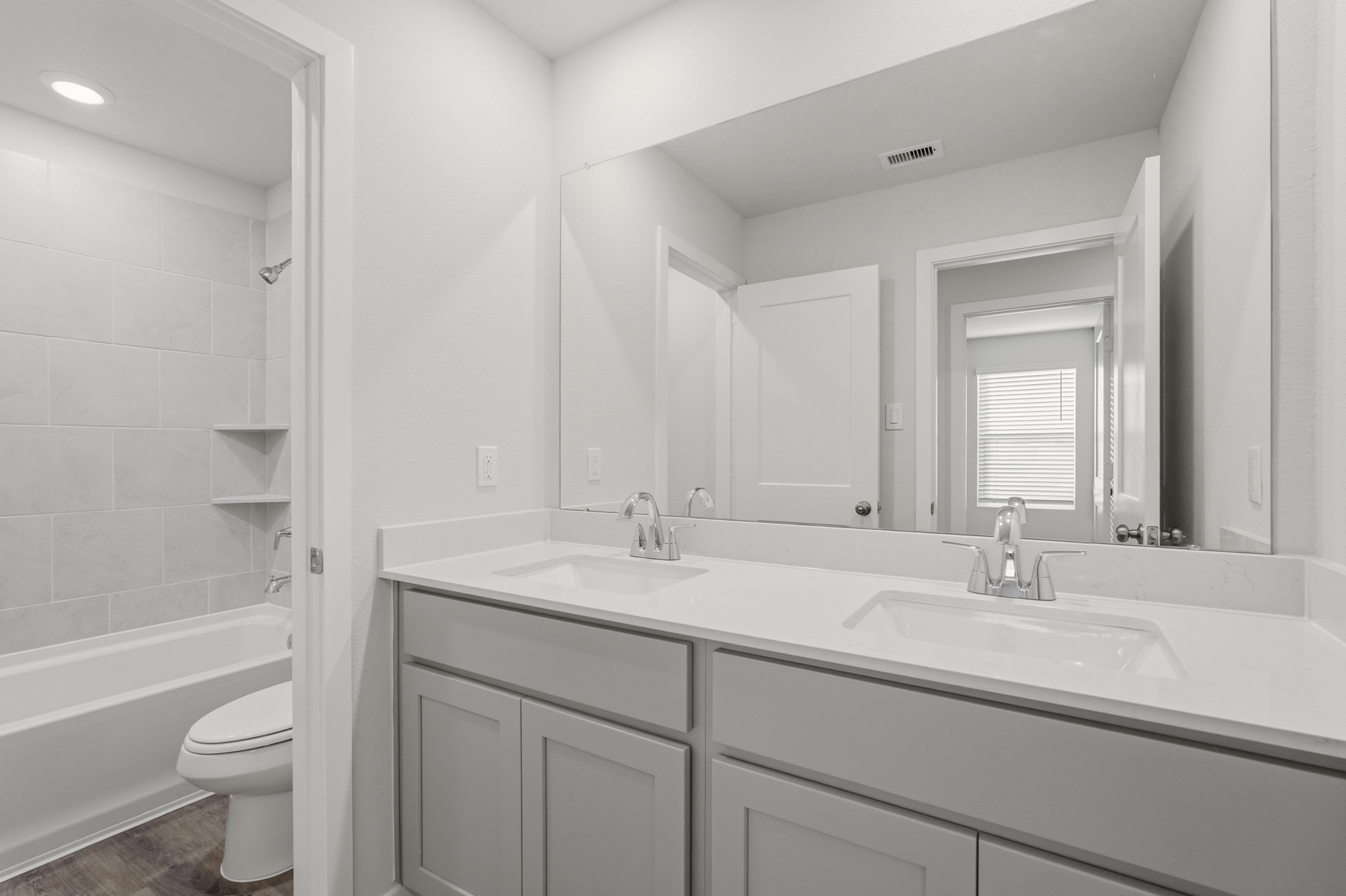 A bathroom with a tub sink and toilet.