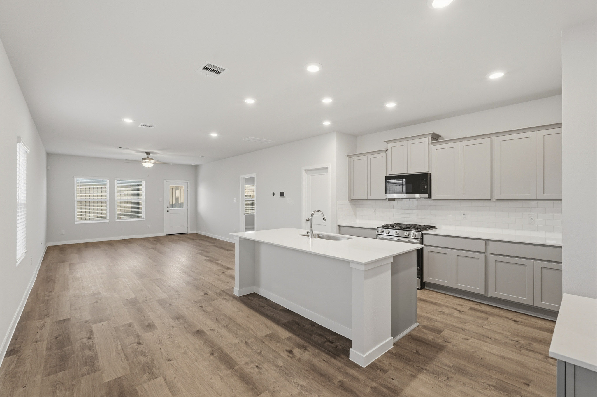 A kitchen with white cabinets.