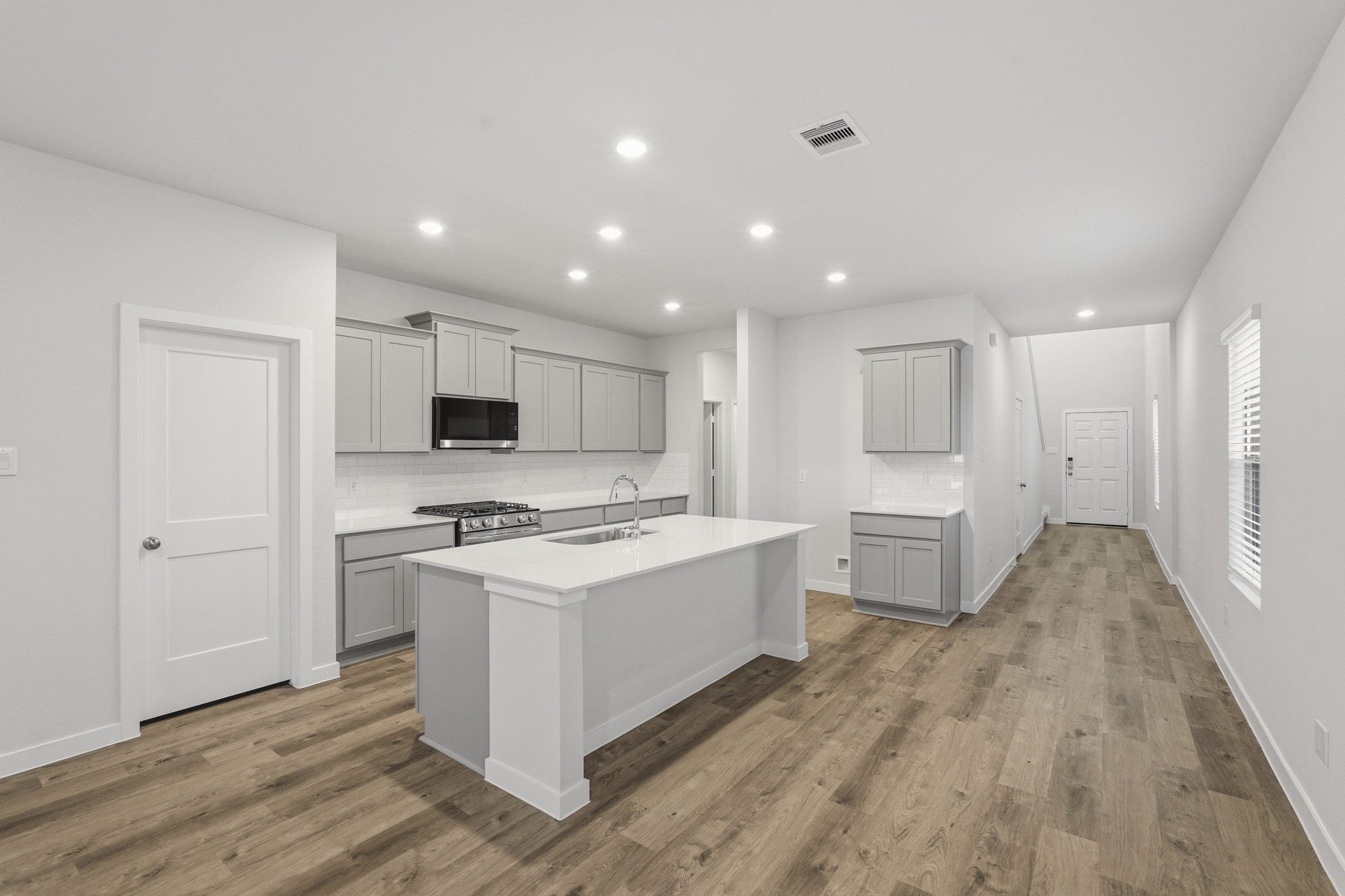 A kitchen with white cabinets.
