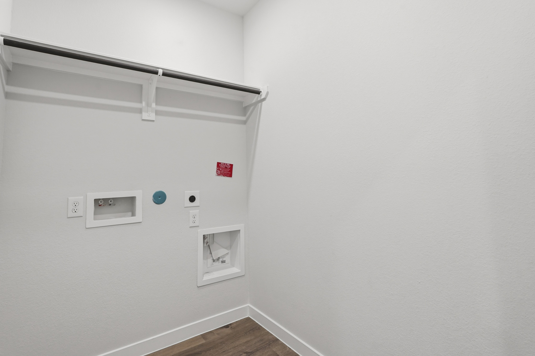 A white wall with a light switch.