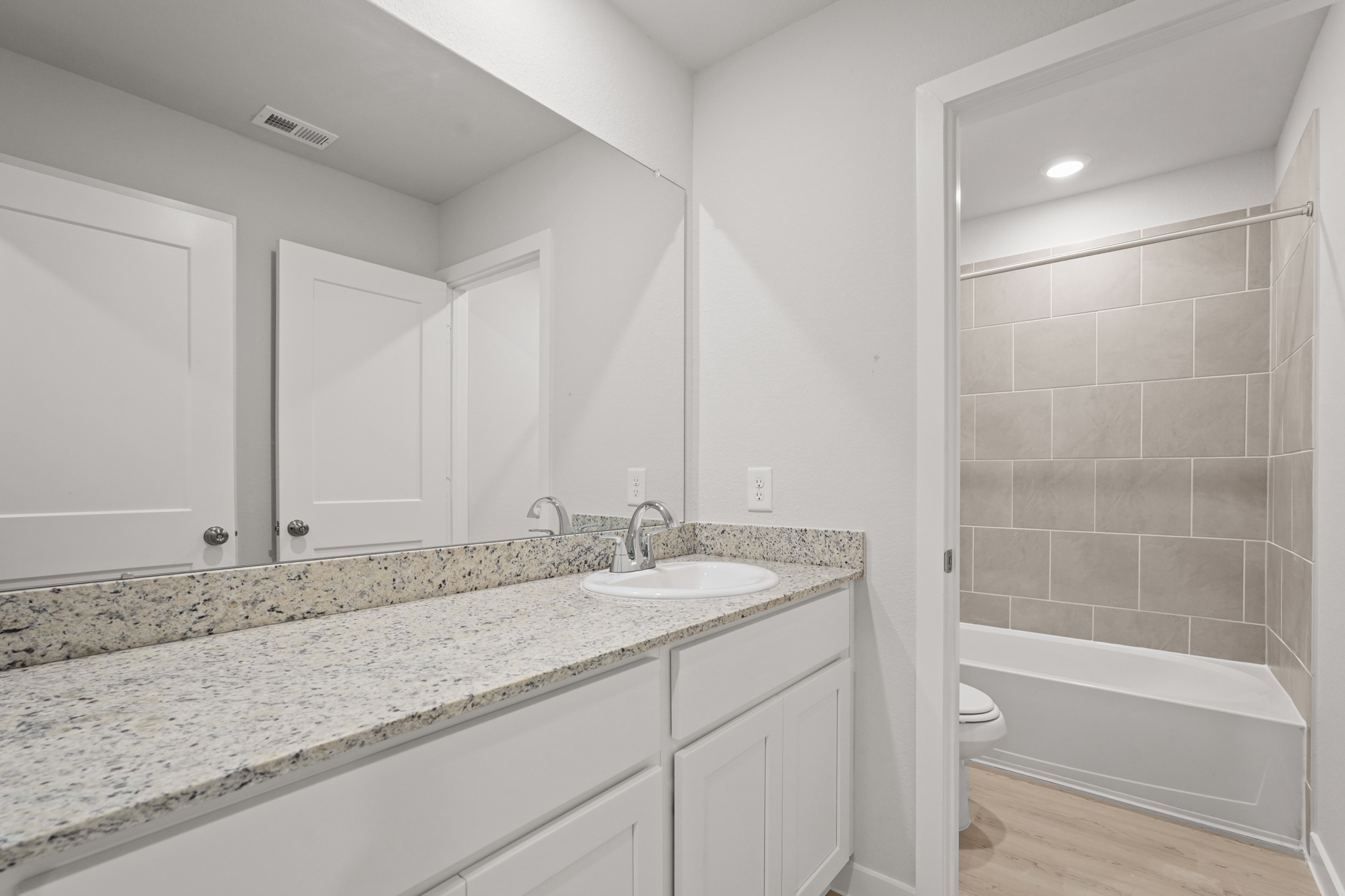 A bathroom with a marble countertop.