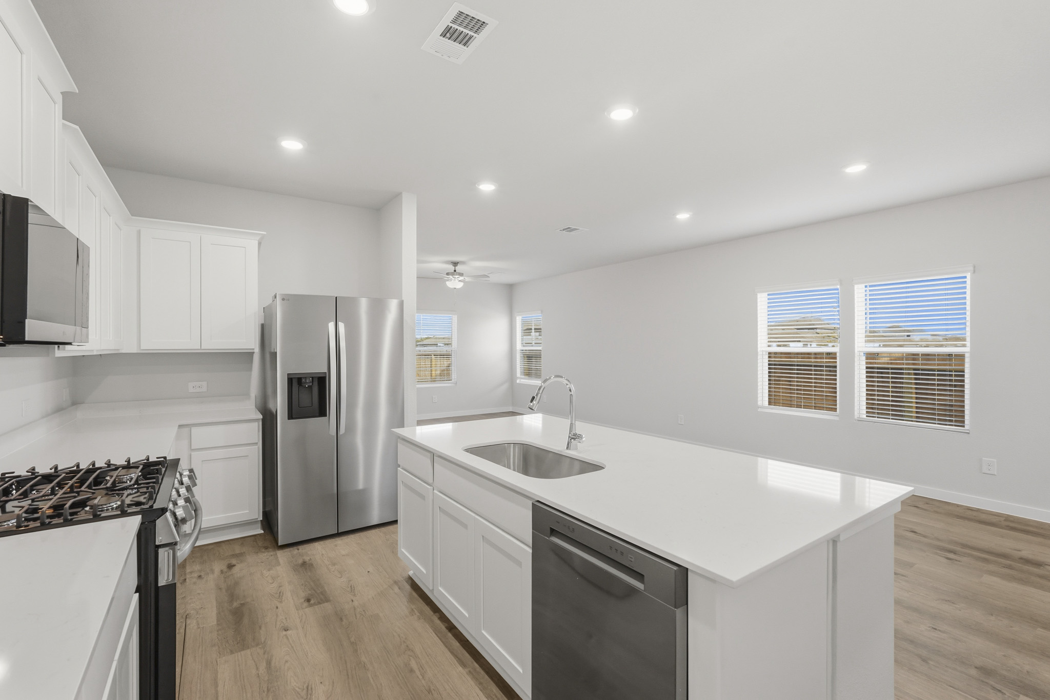 A kitchen with white cabinets.