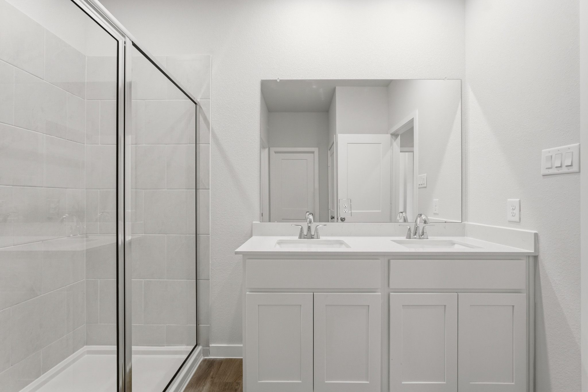A bathroom with a glass shower.