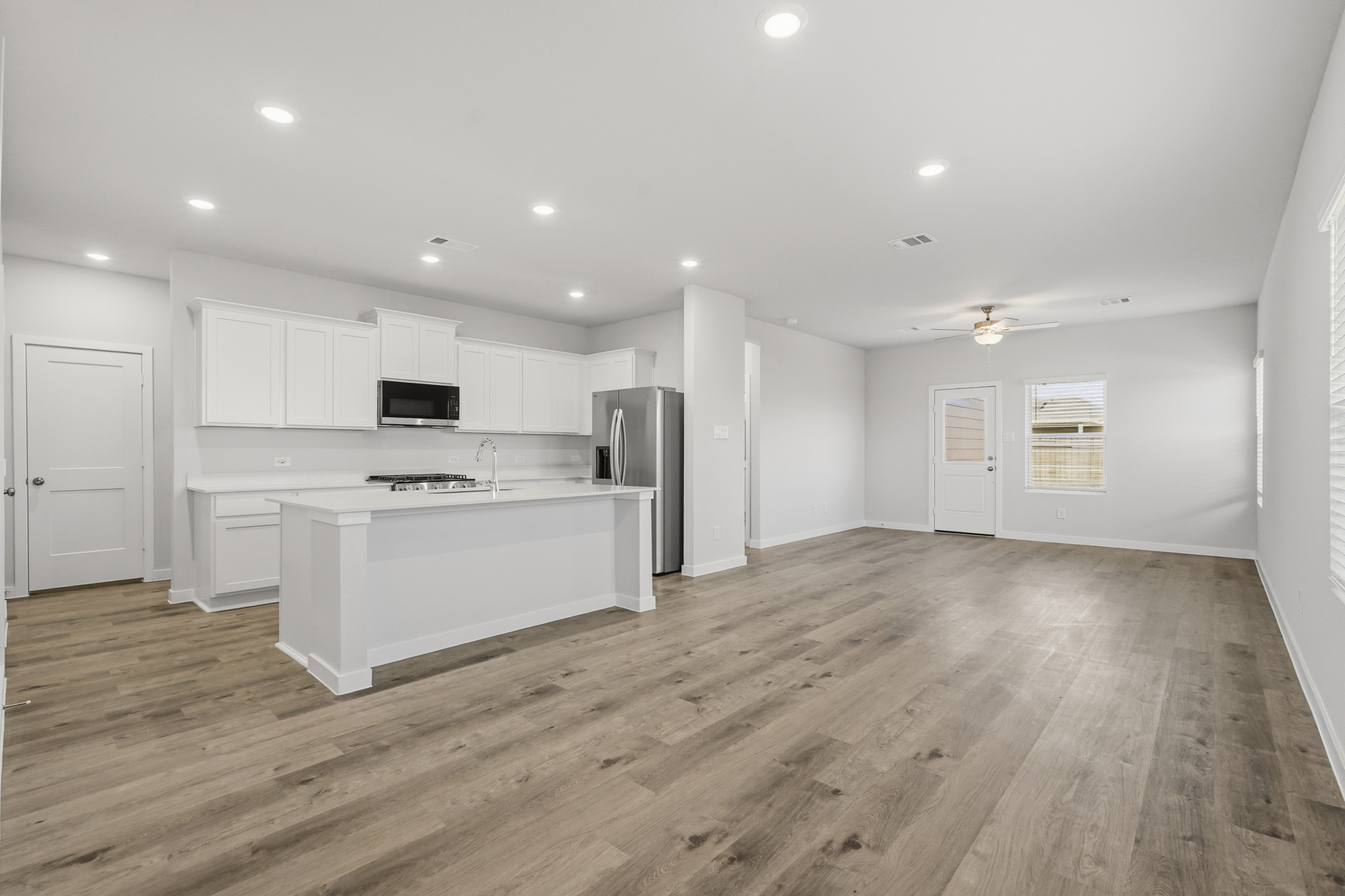 A kitchen with white cabinets.