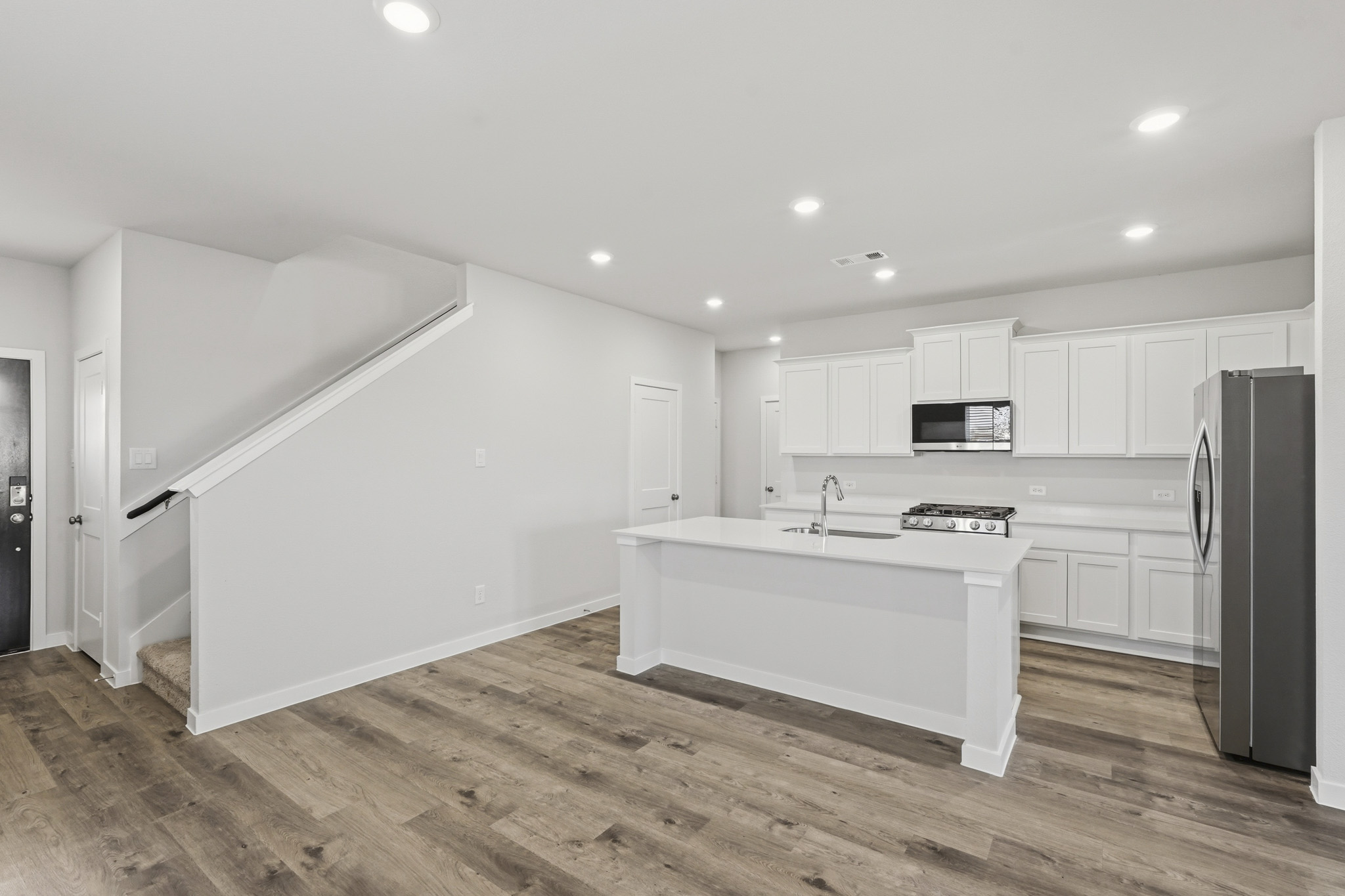A kitchen with white cabinets.
