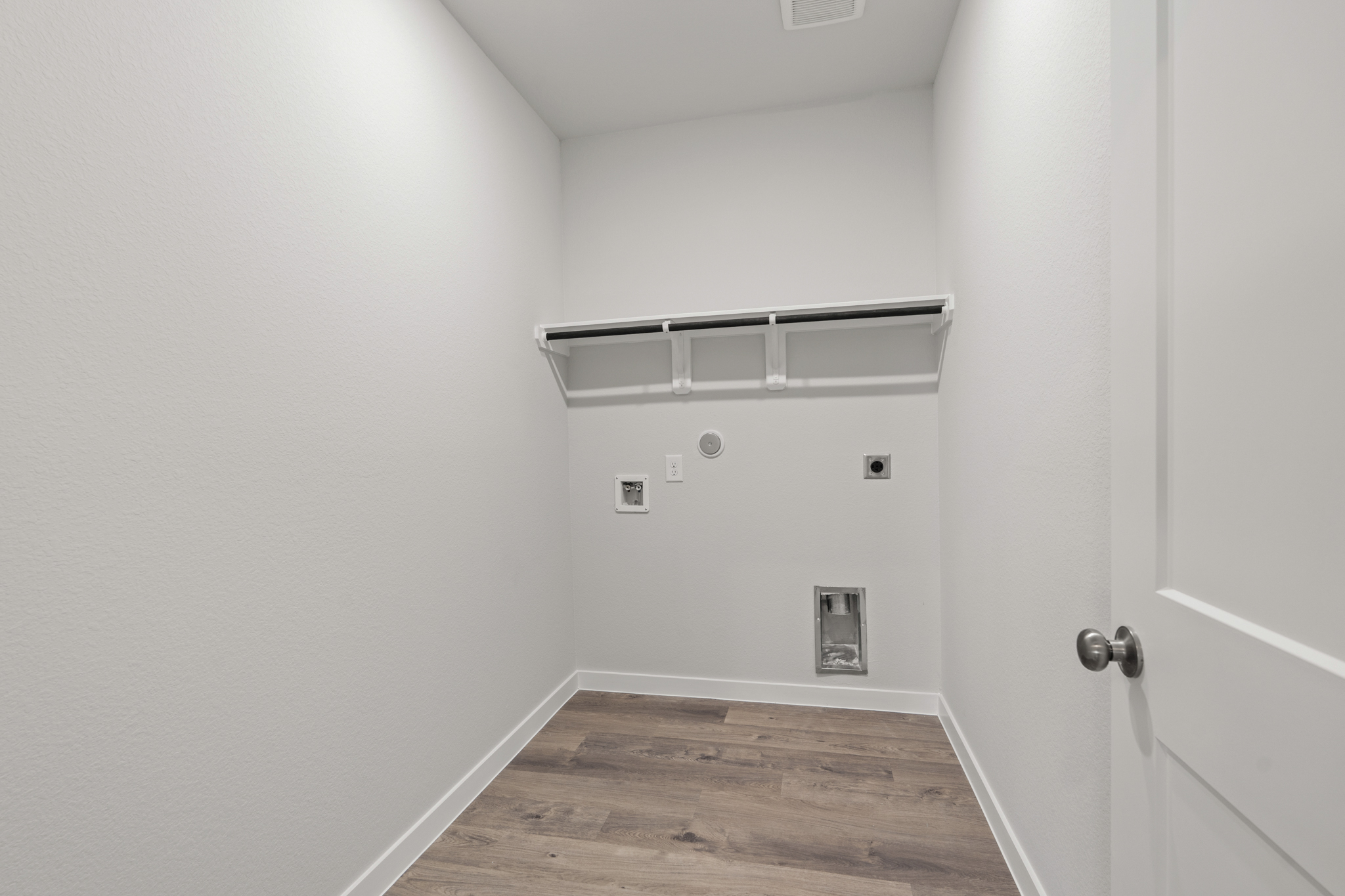 A room with white walls and a wood floor.