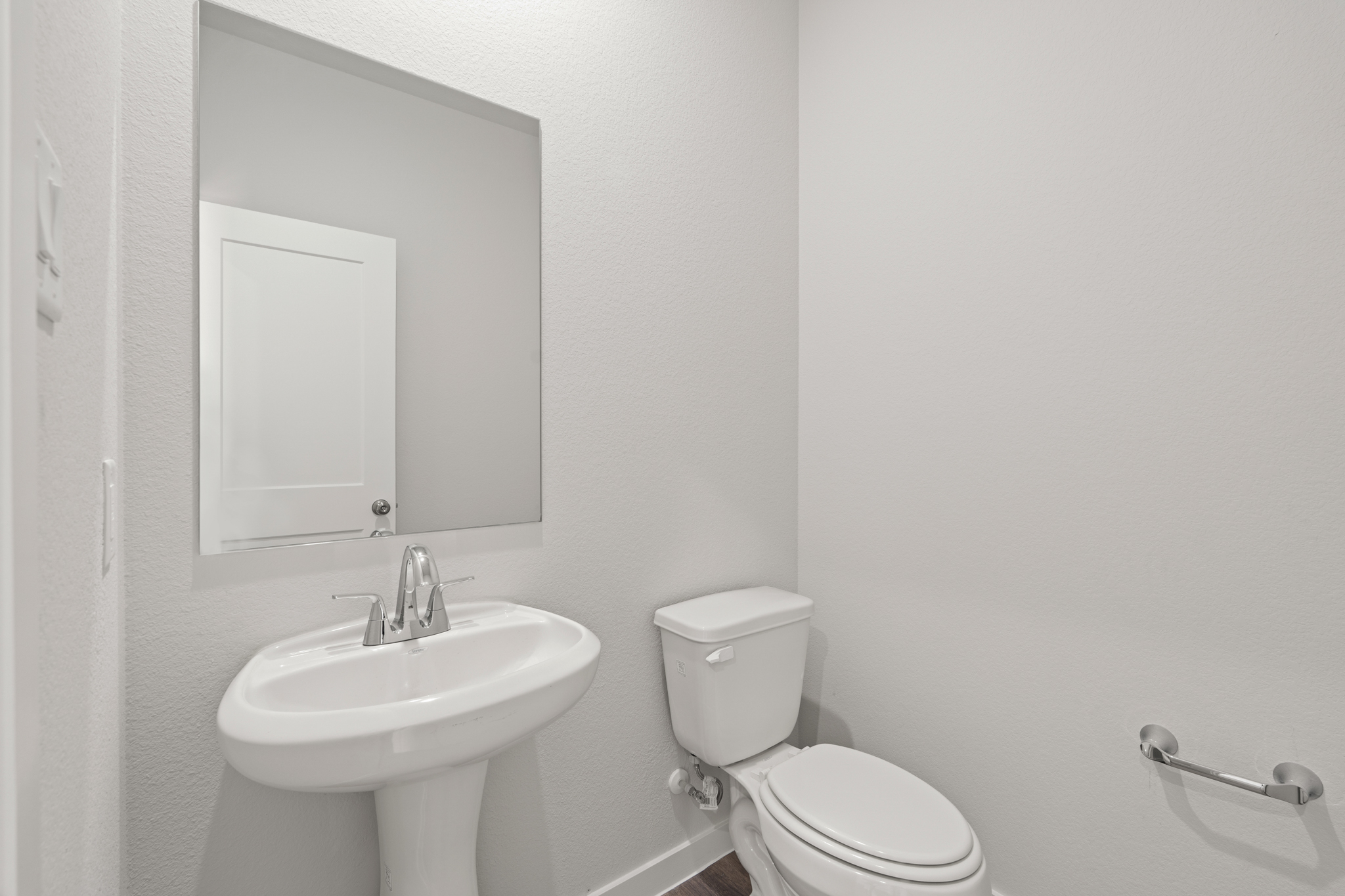 A bathroom with a toilet and sink.