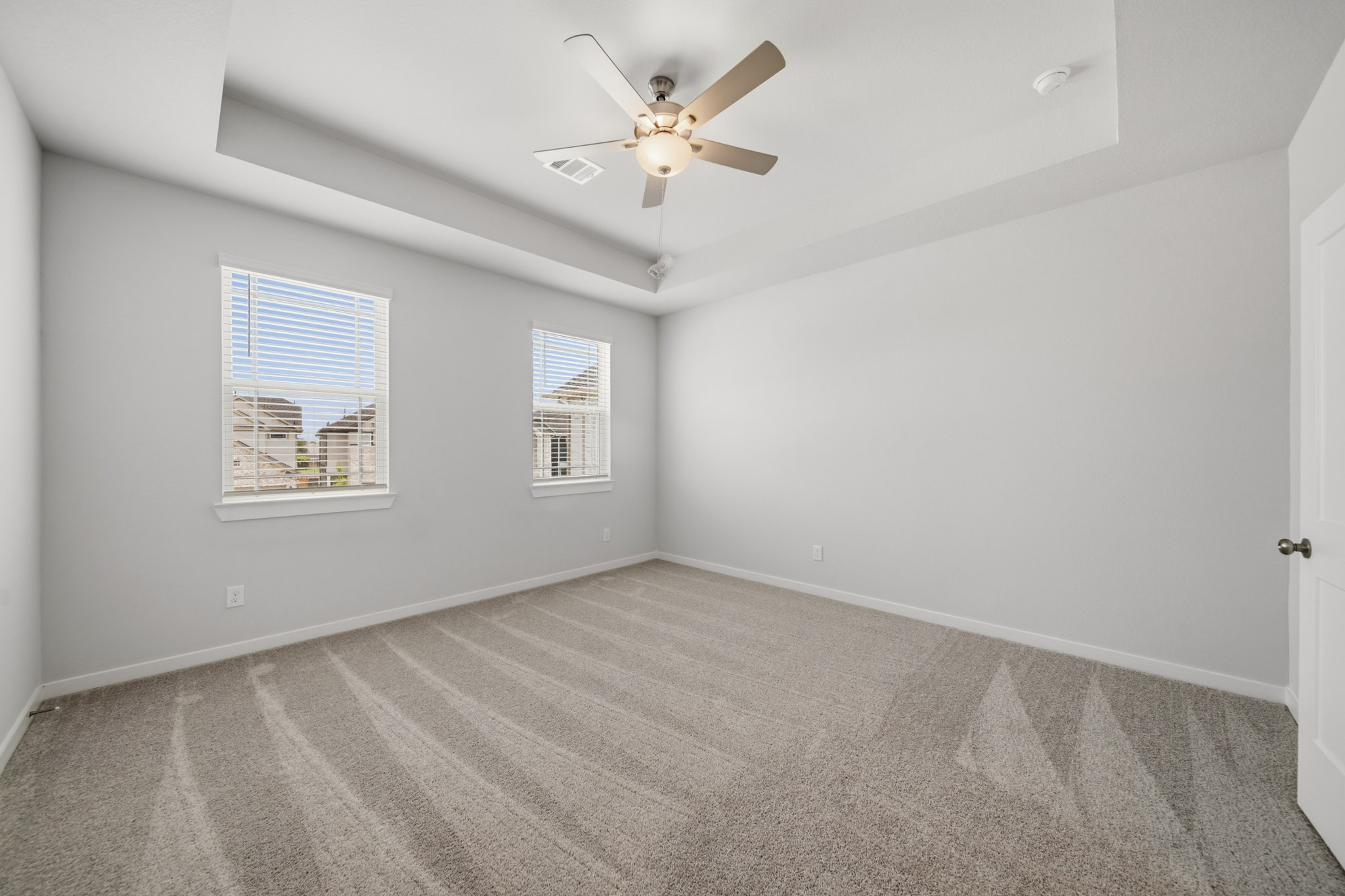 A room with a ceiling fan and a ceiling fan.