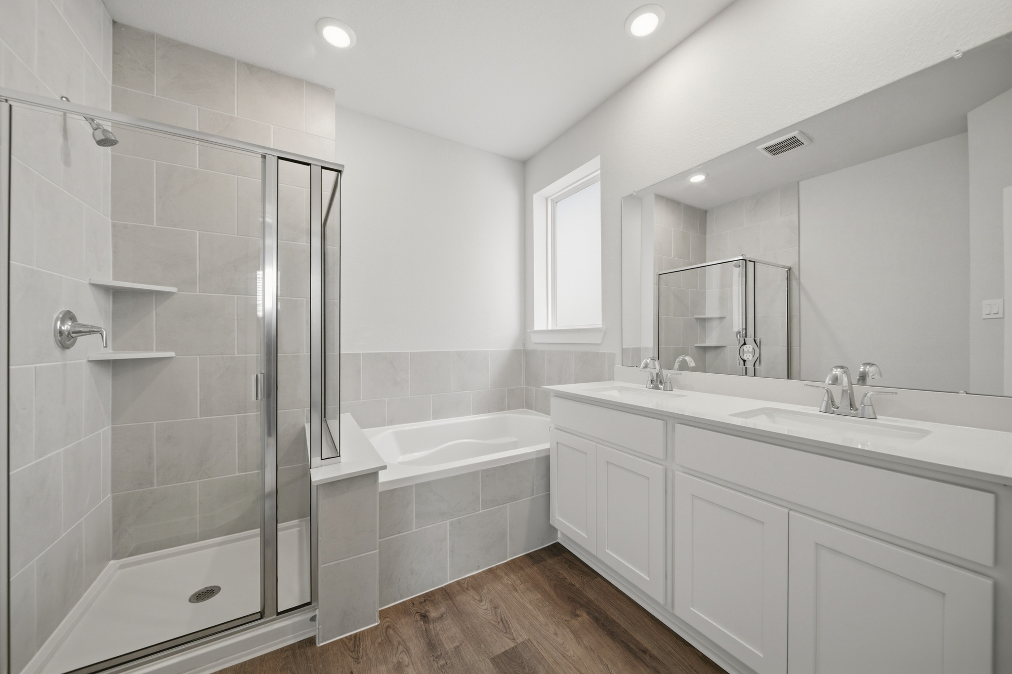 A bathroom with a tub sink and a shower.