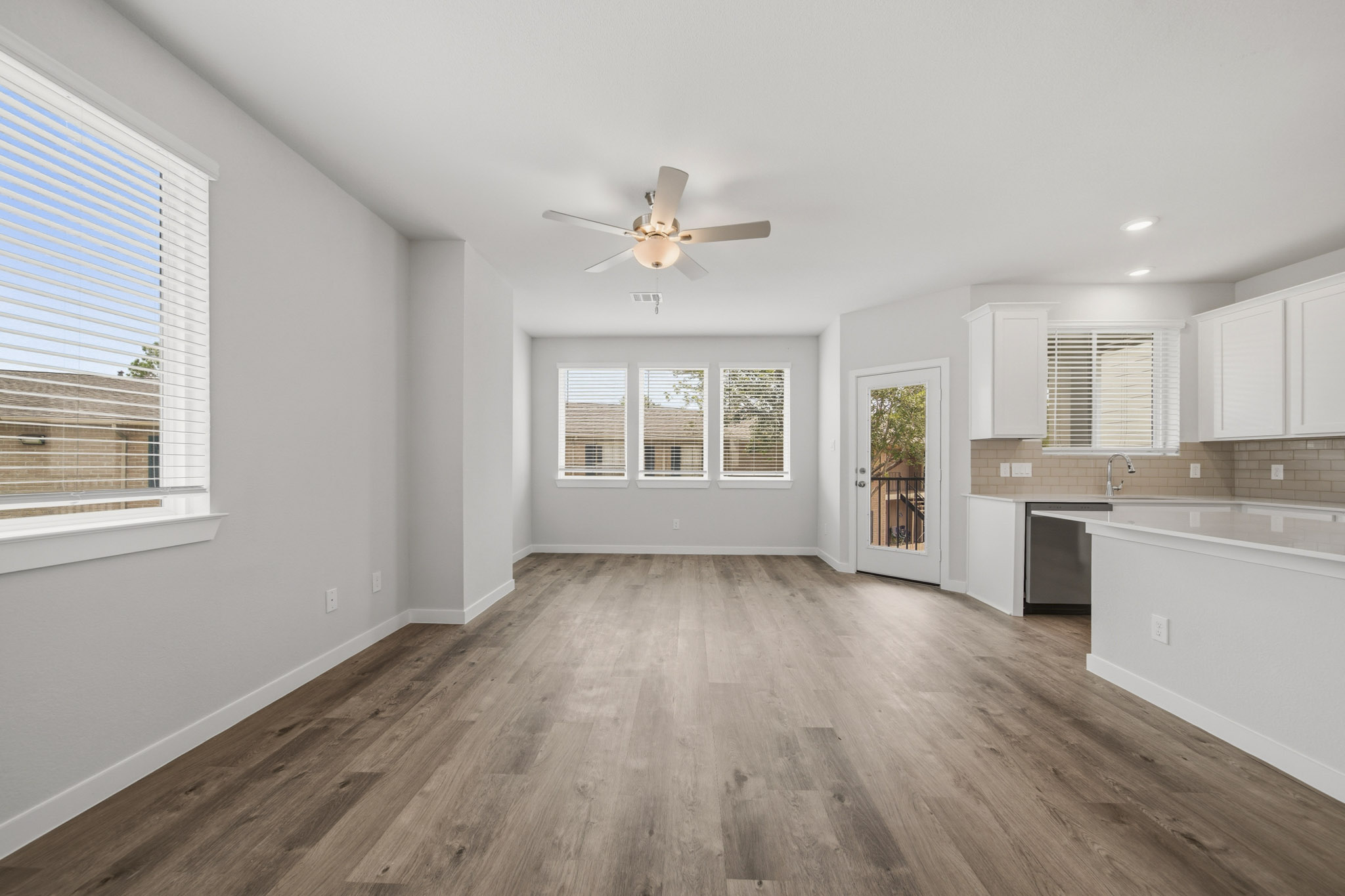 A kitchen with white cabinets.