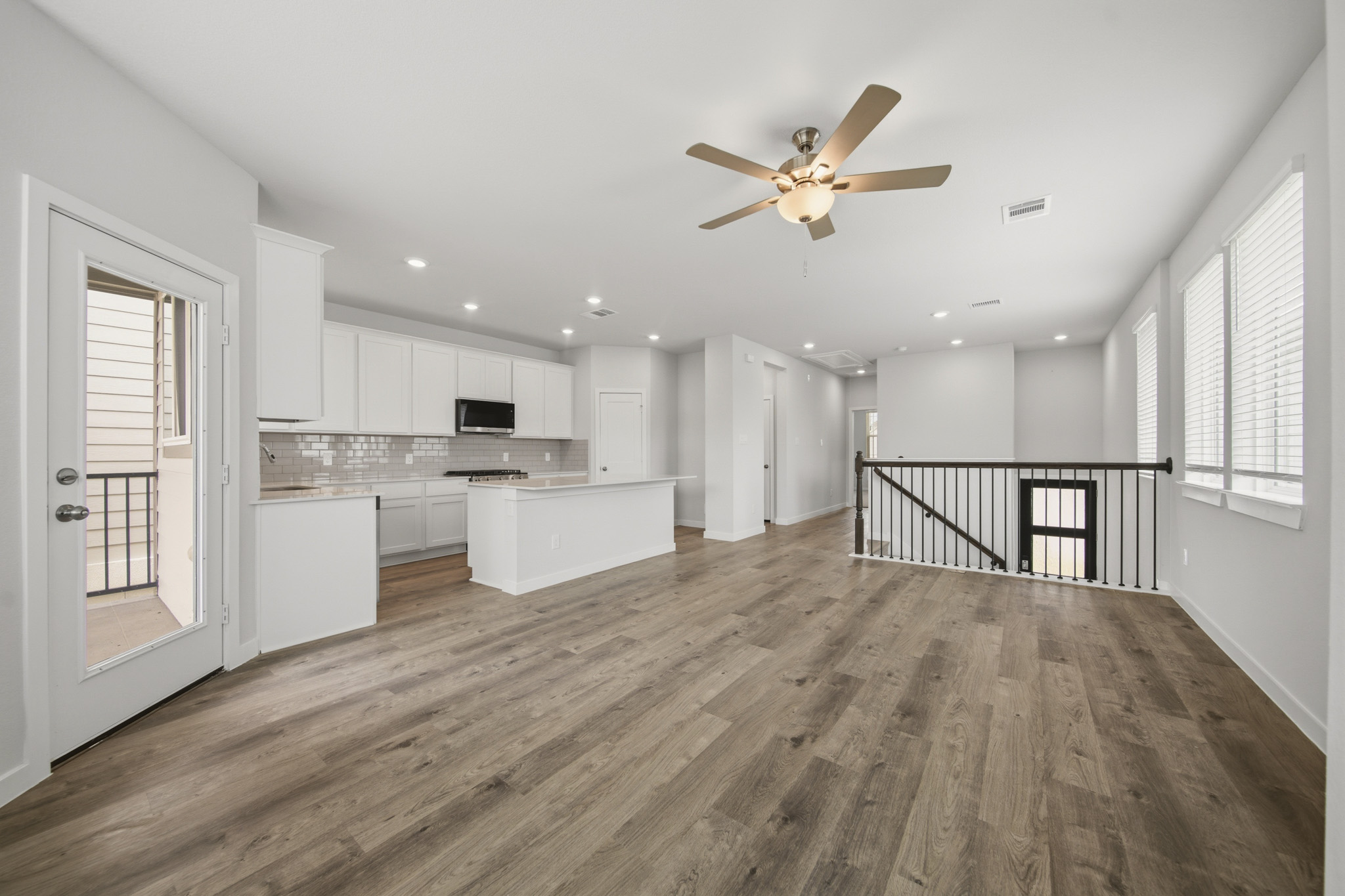 A kitchen with white cabinets.