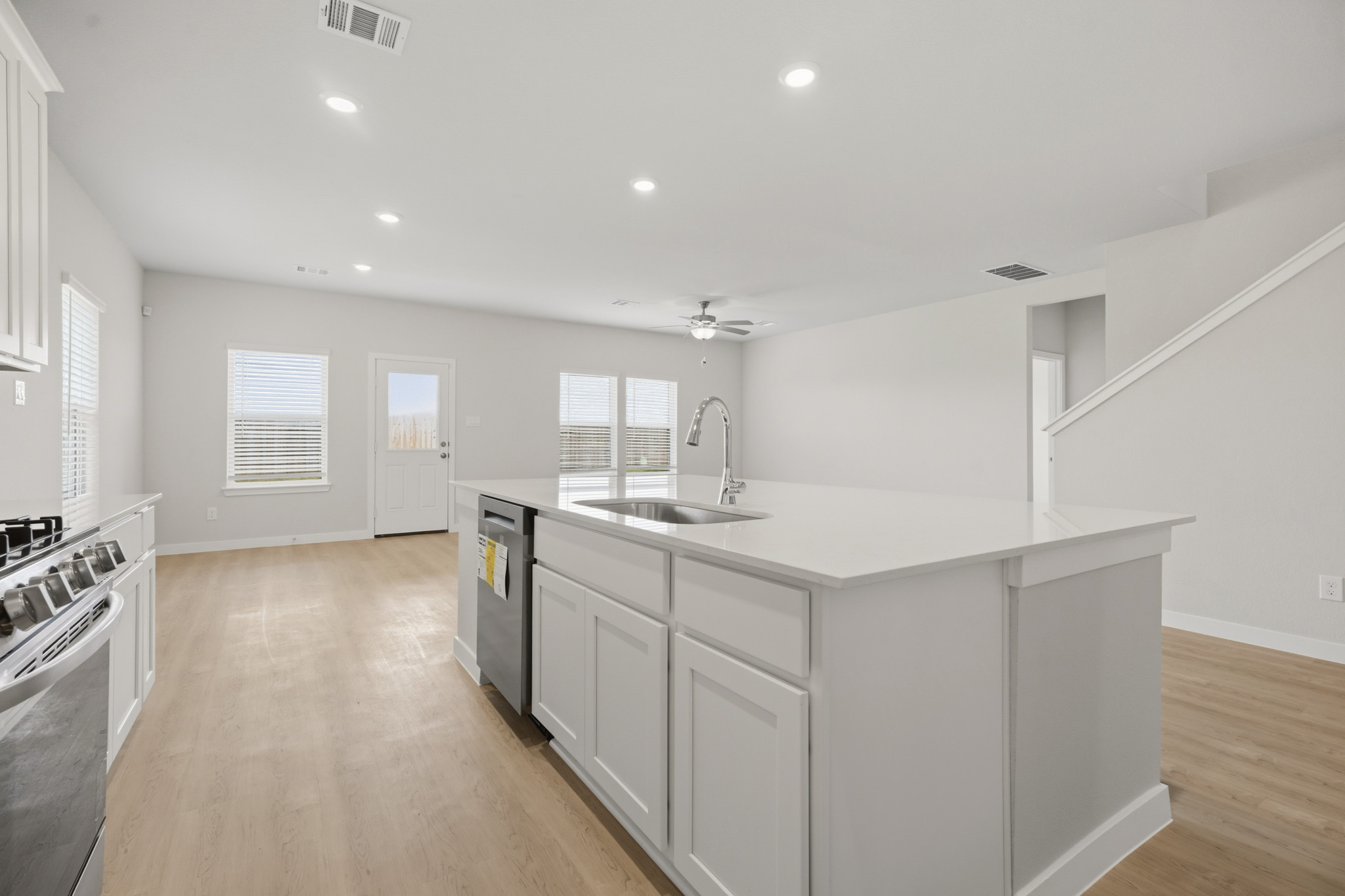 A kitchen with white cabinets.