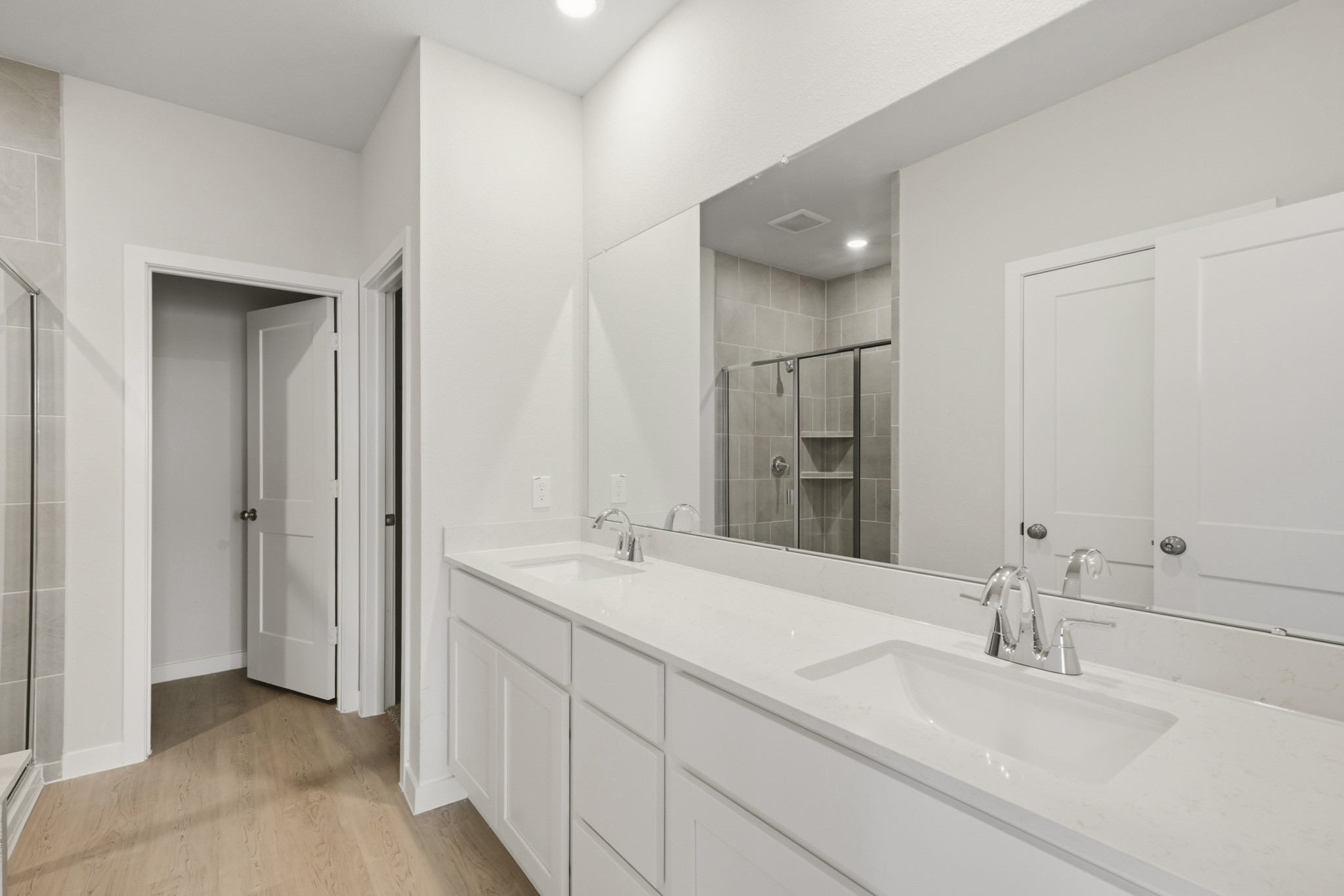 A bathroom with a large mirror.