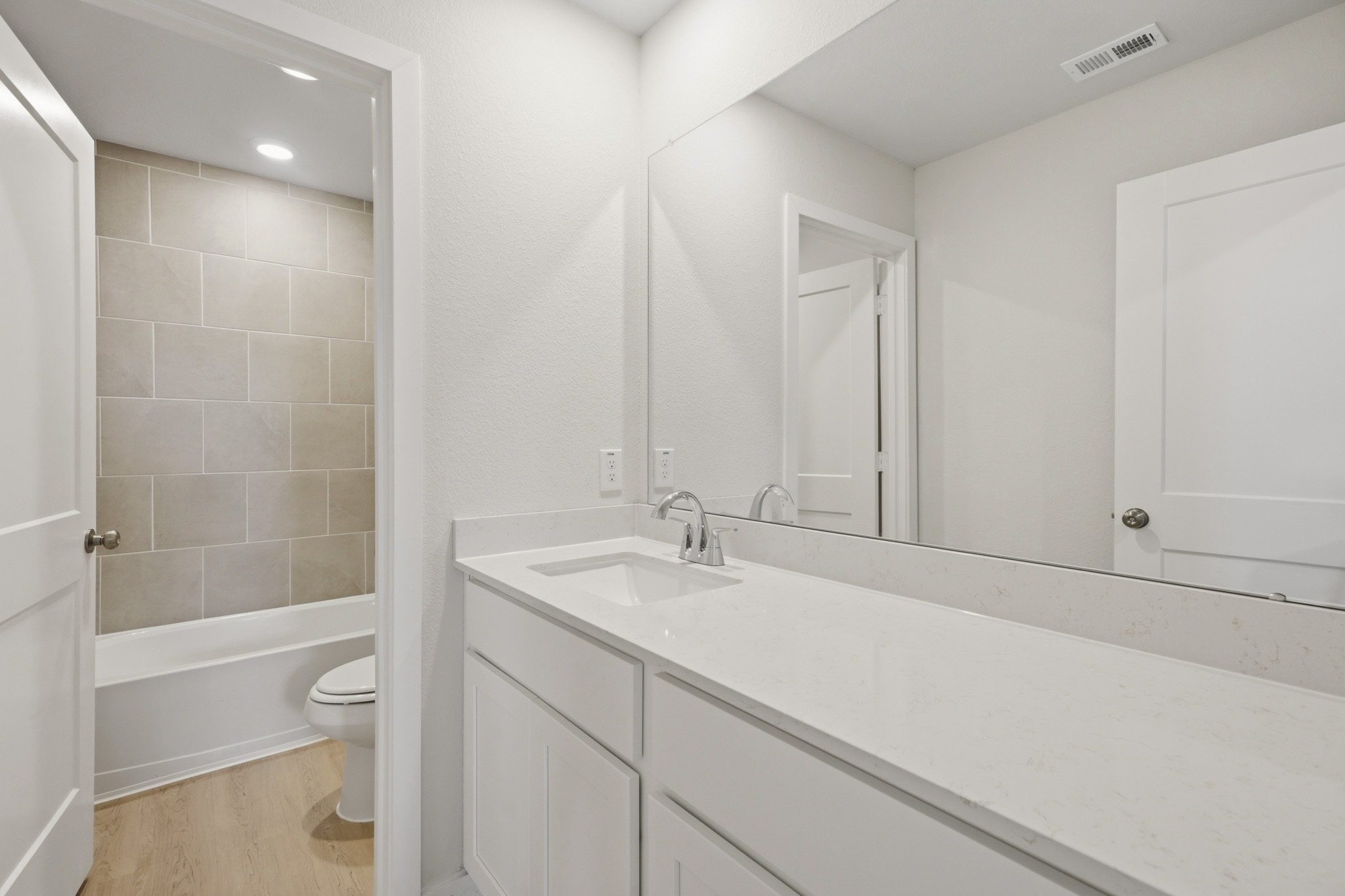 A bathroom with a tub sink and toilet.