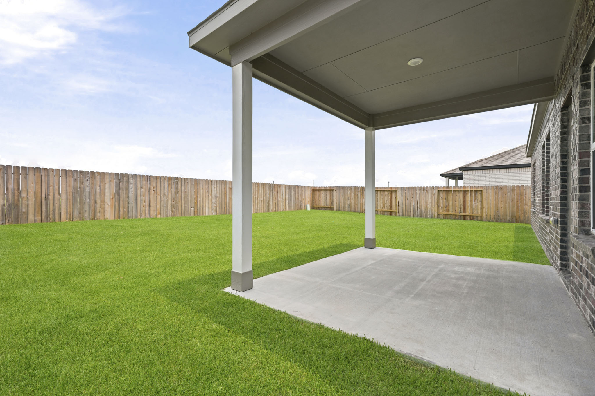 A backyard with a fence.