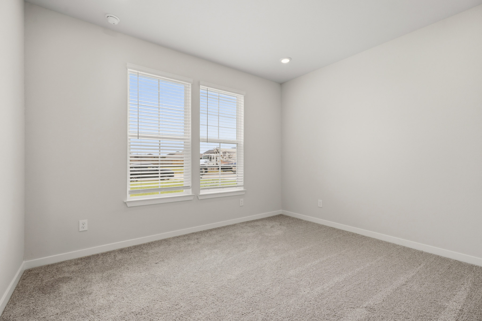 A room with a window and a carpet.