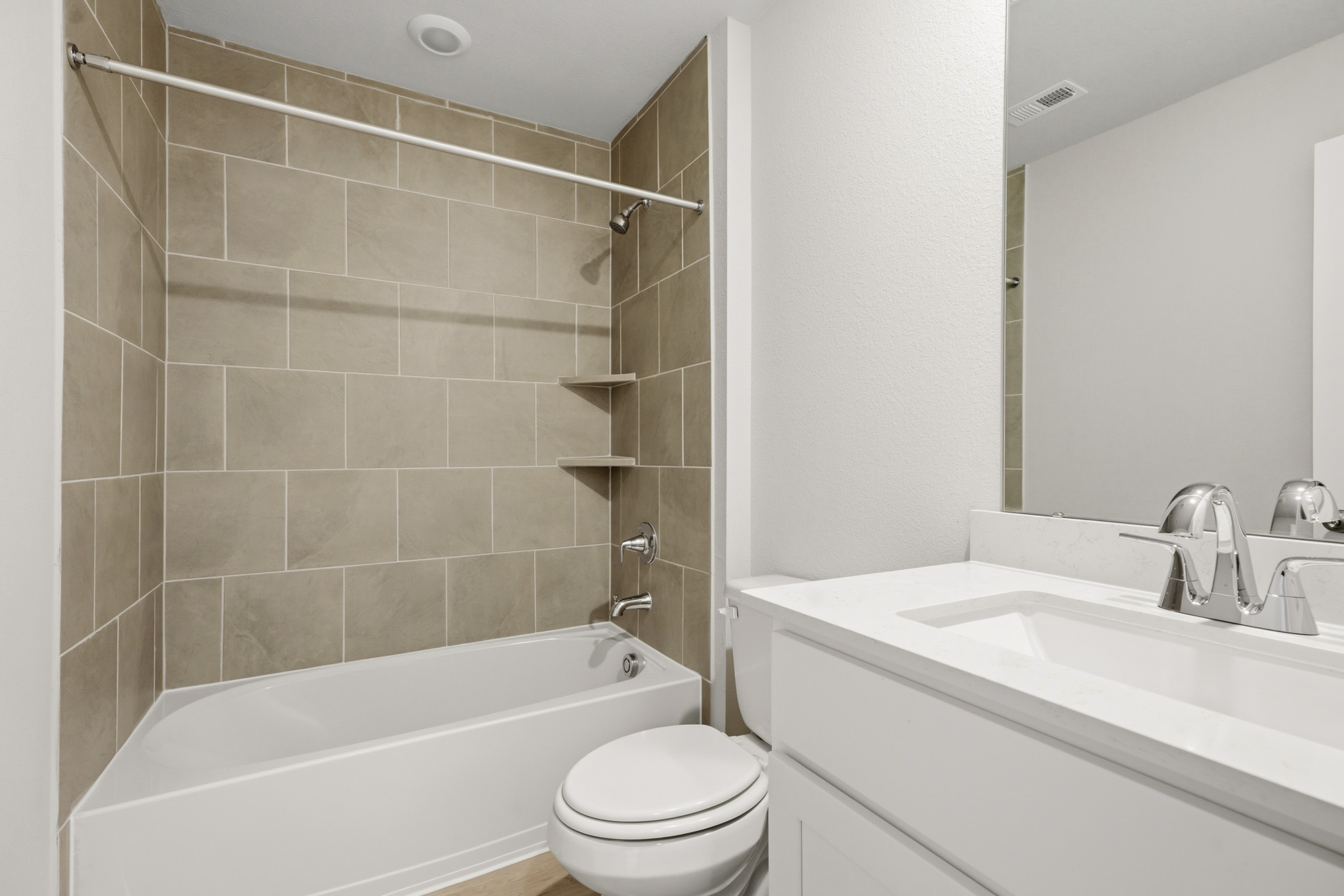 A bathroom with a tub sink and toilet.