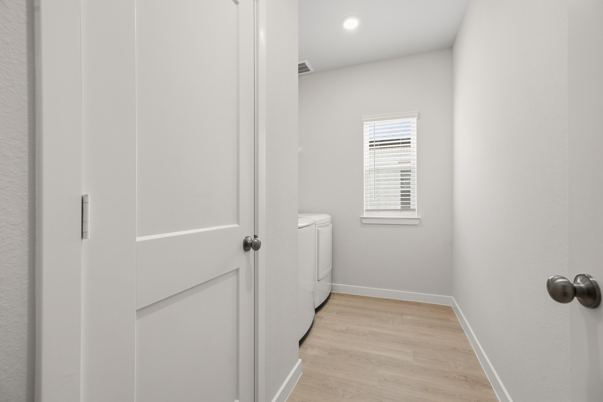 A hallway with white doors.